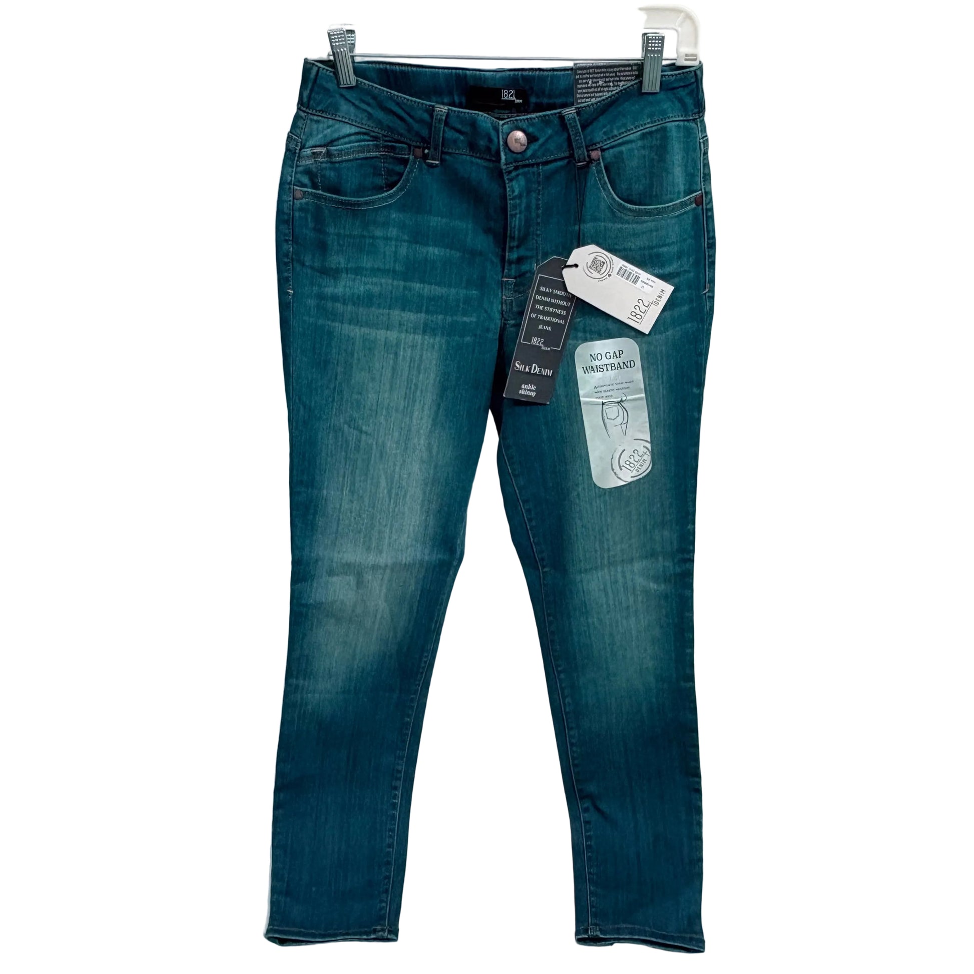 Blue jeans with tags on a white background