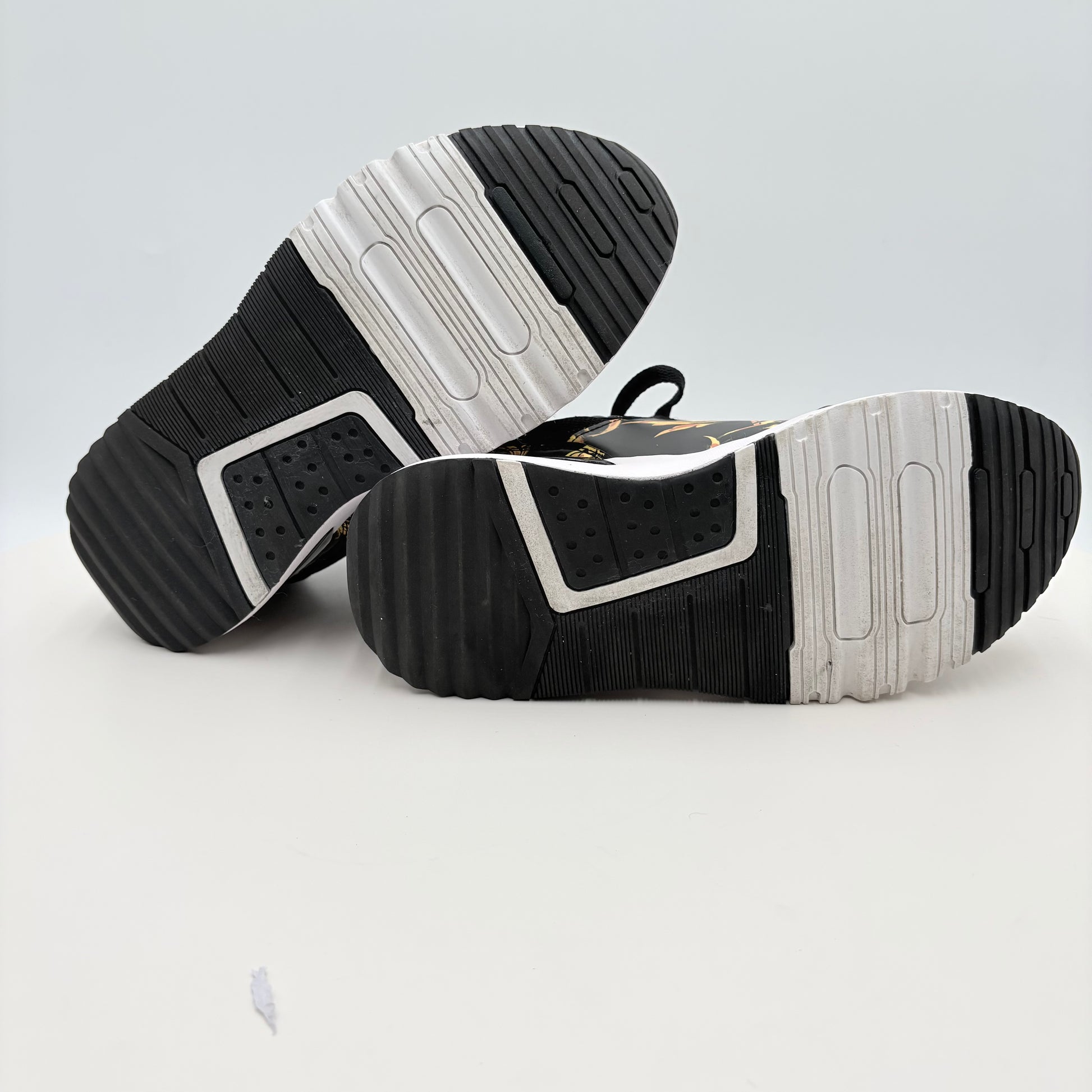 Black and white athletic shoes on a light gray background