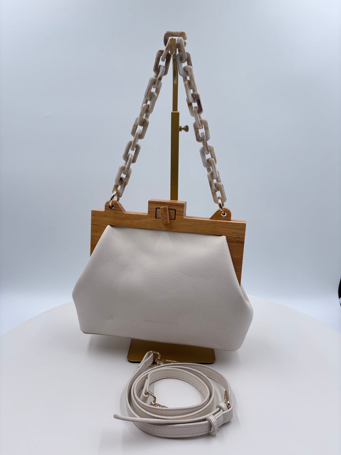 Cream color handbag with crossbody strap and handbag strap