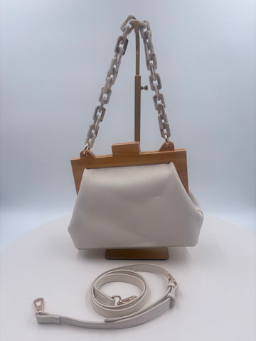 Cream color handbag with crossbody strap and handbag strap