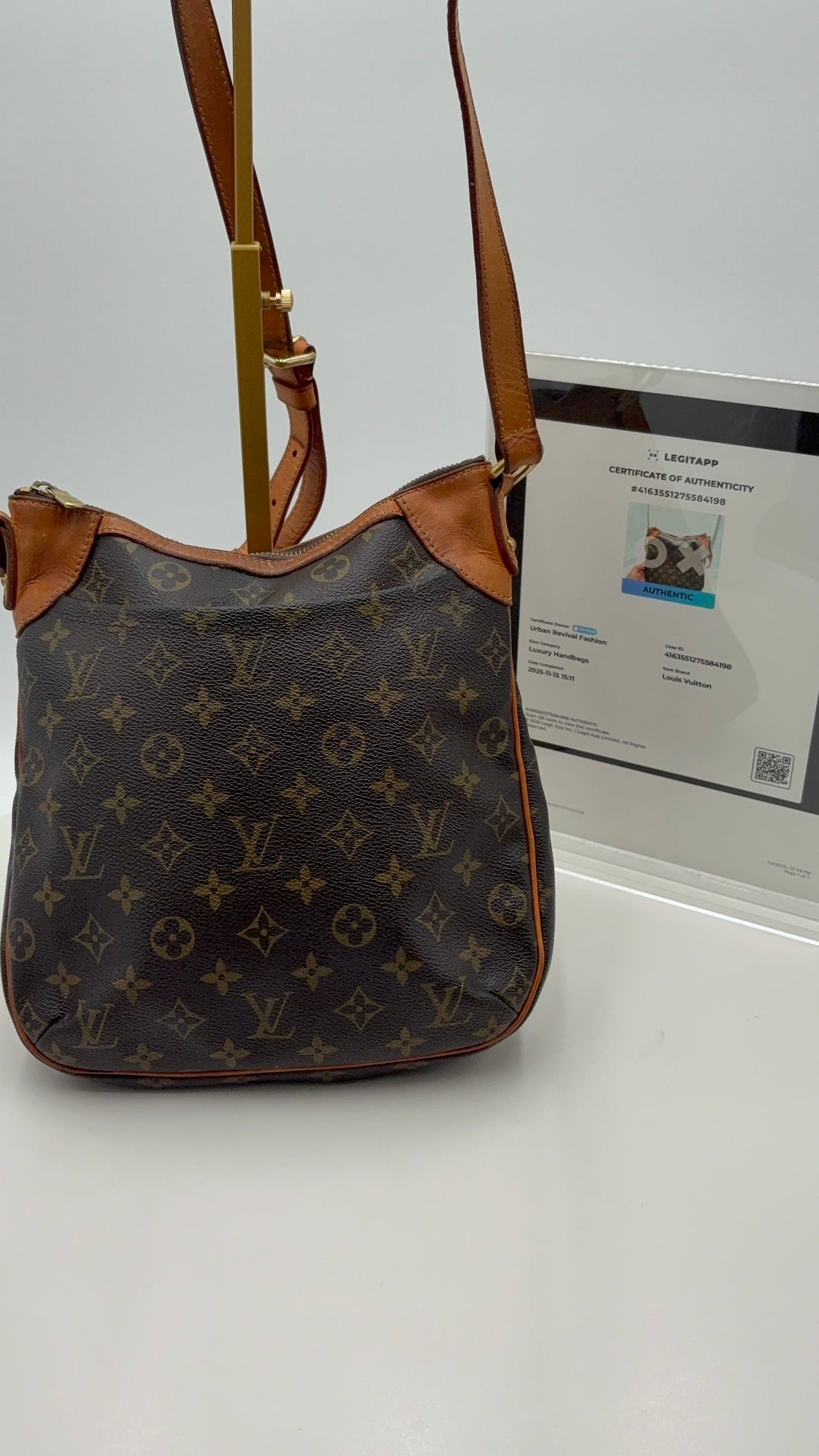 Designer handbag with monogram pattern on a white background