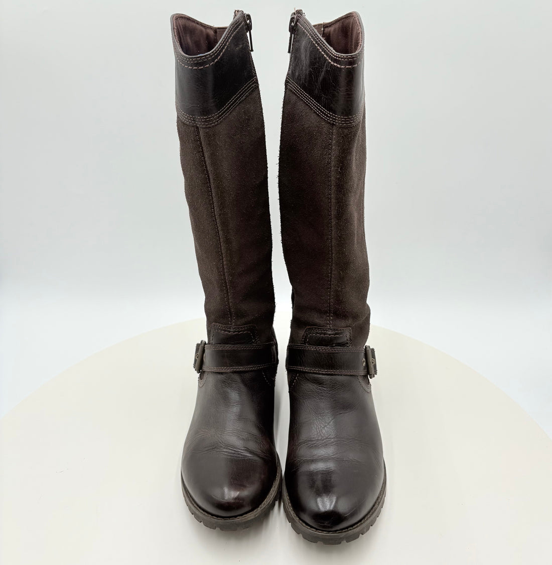 Pair of brown knee-high boots on a white background