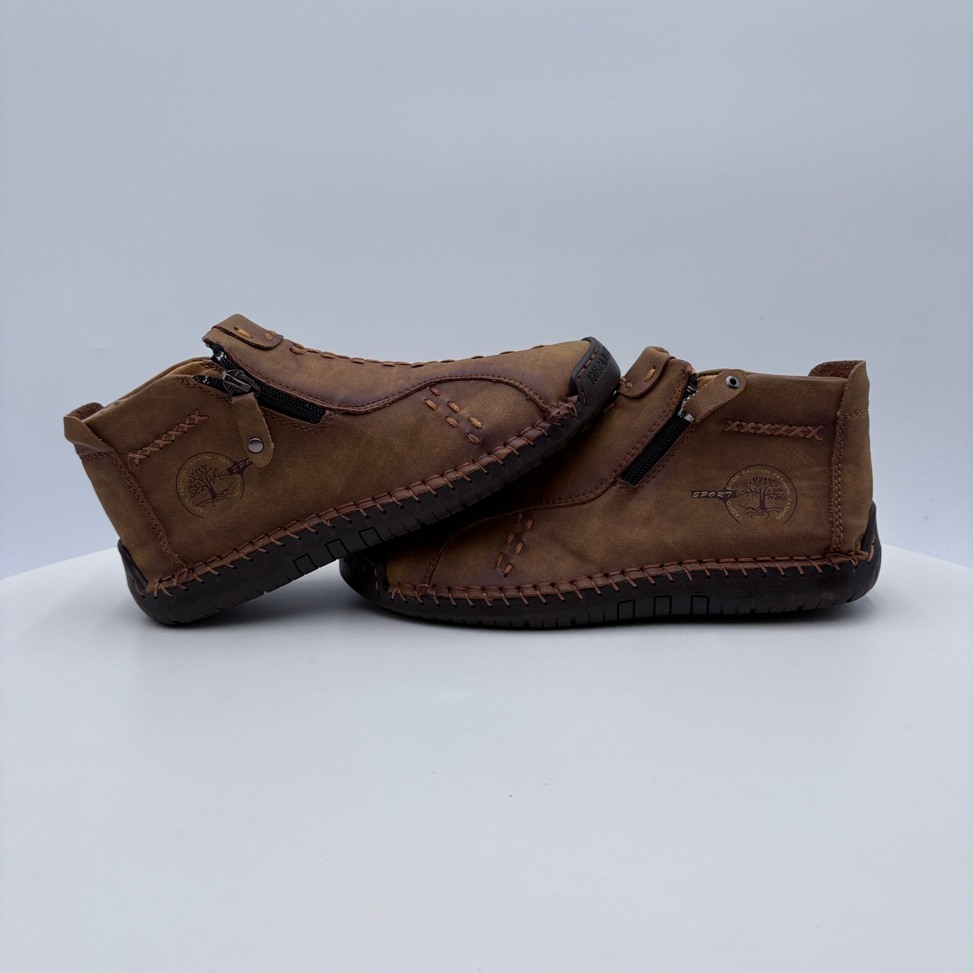 Pair of brown leather shoes on a light gray background