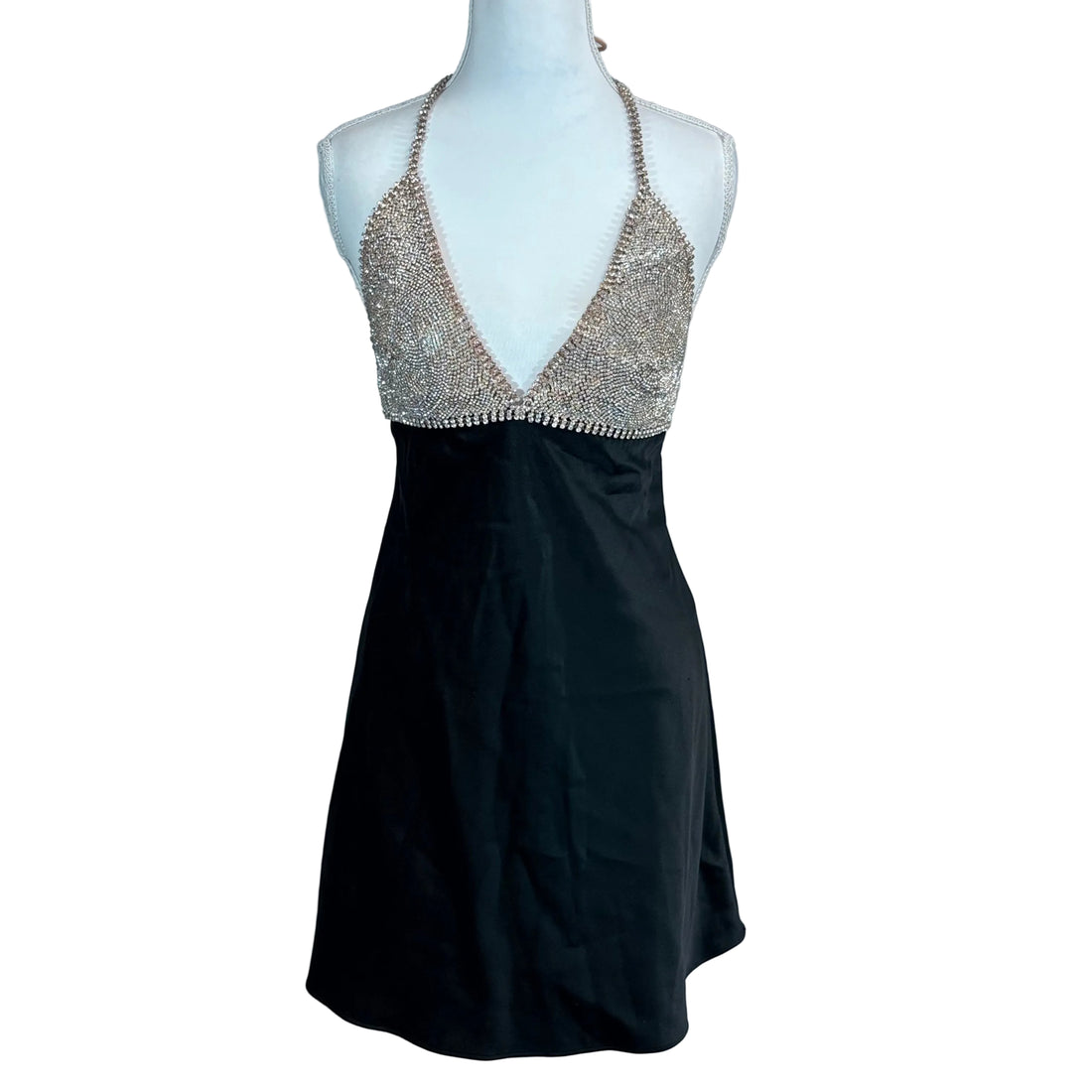 Black dress with a beaded top on a mannequin against a white background
