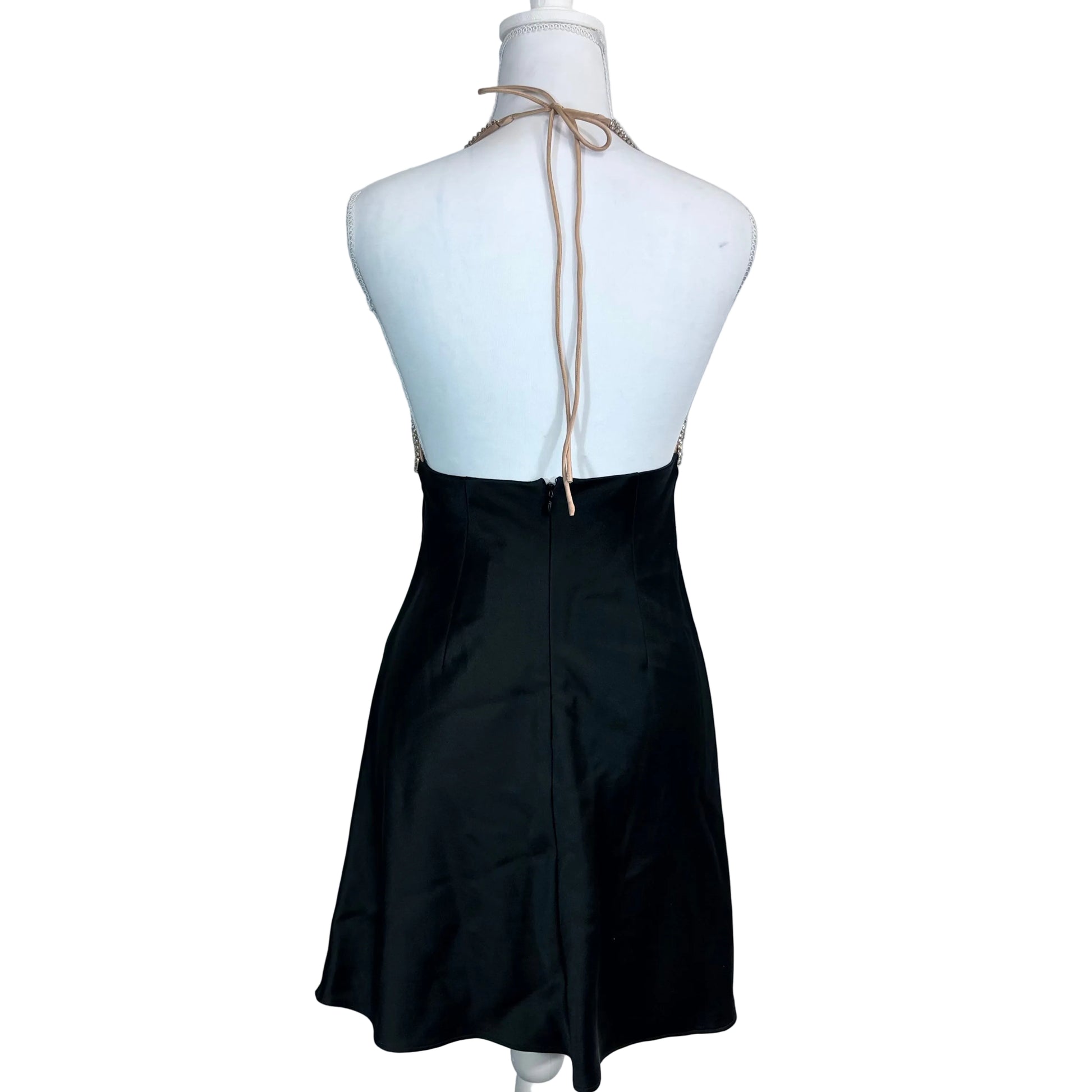 Black dress on a mannequin with a plain background