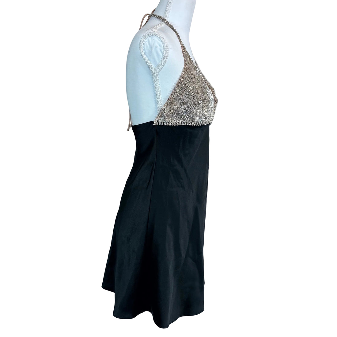 Black dress with a beaded top on a mannequin against a white background