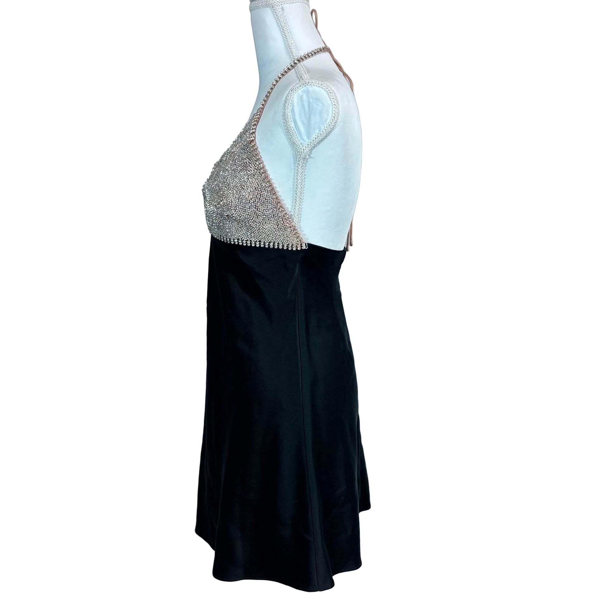 Mannequin wearing a black and silver dress against a white background