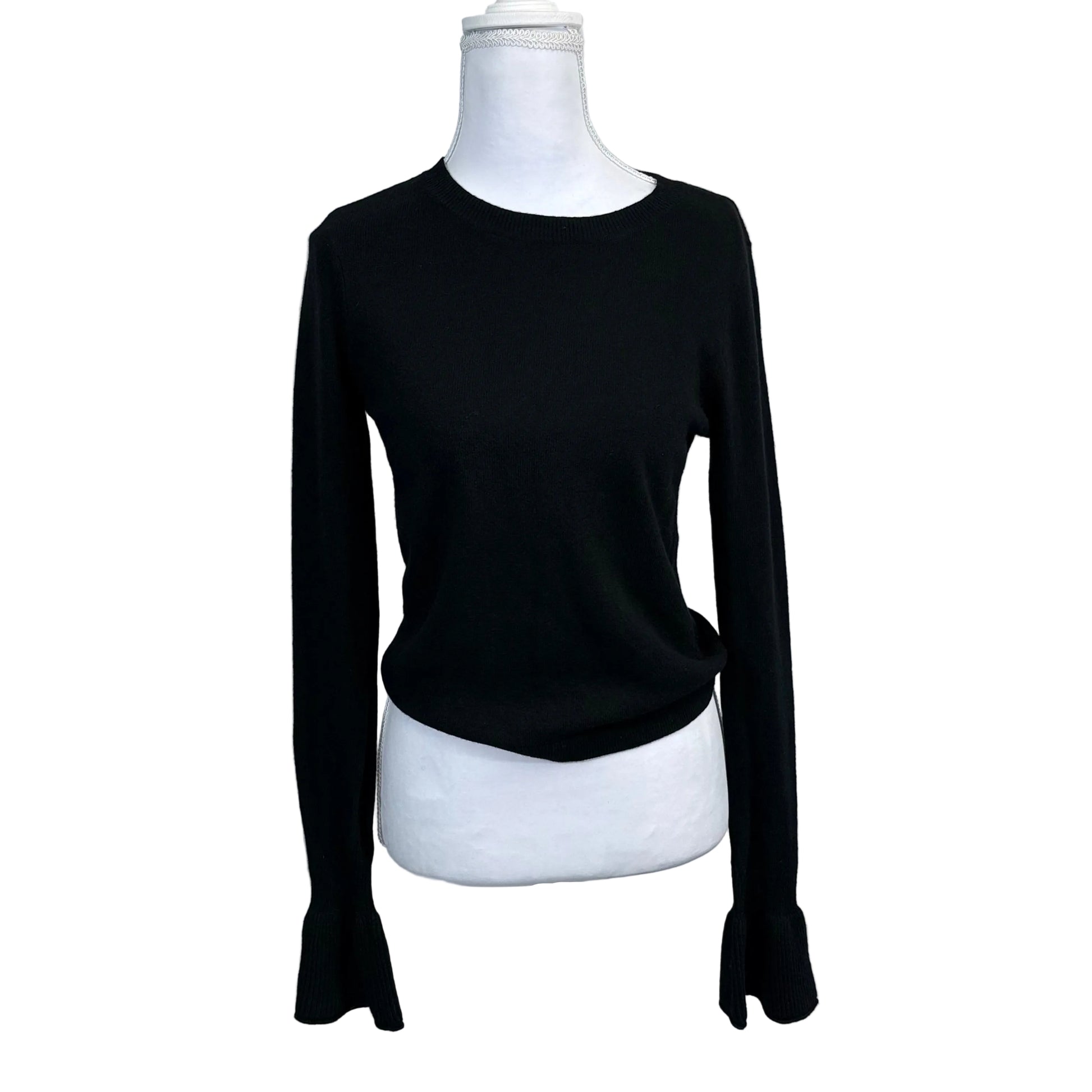 Black long-sleeve shirt on a mannequin against a plain background