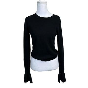 Black long-sleeve shirt on a mannequin against a plain background