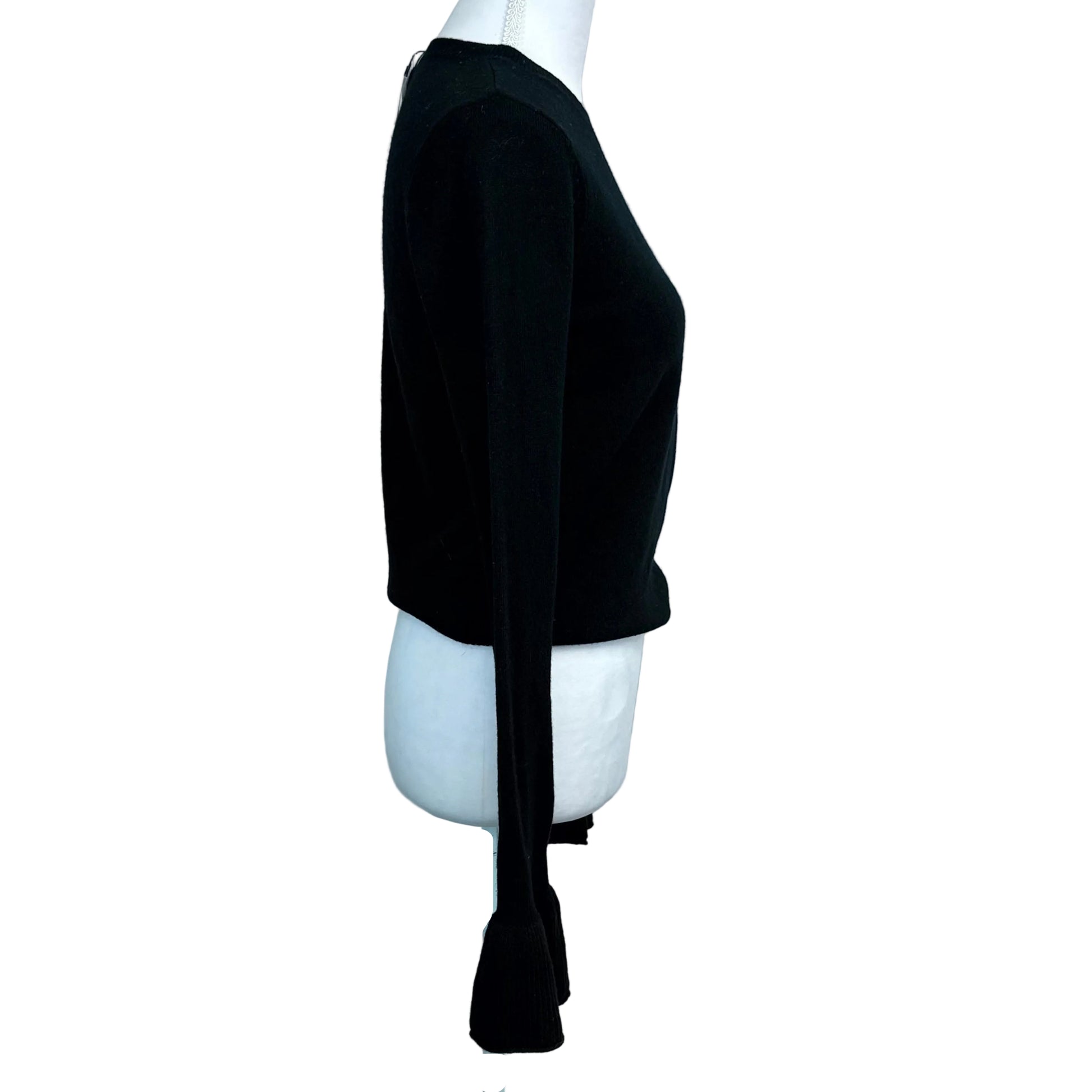 Black sweater on a mannequin against a white background