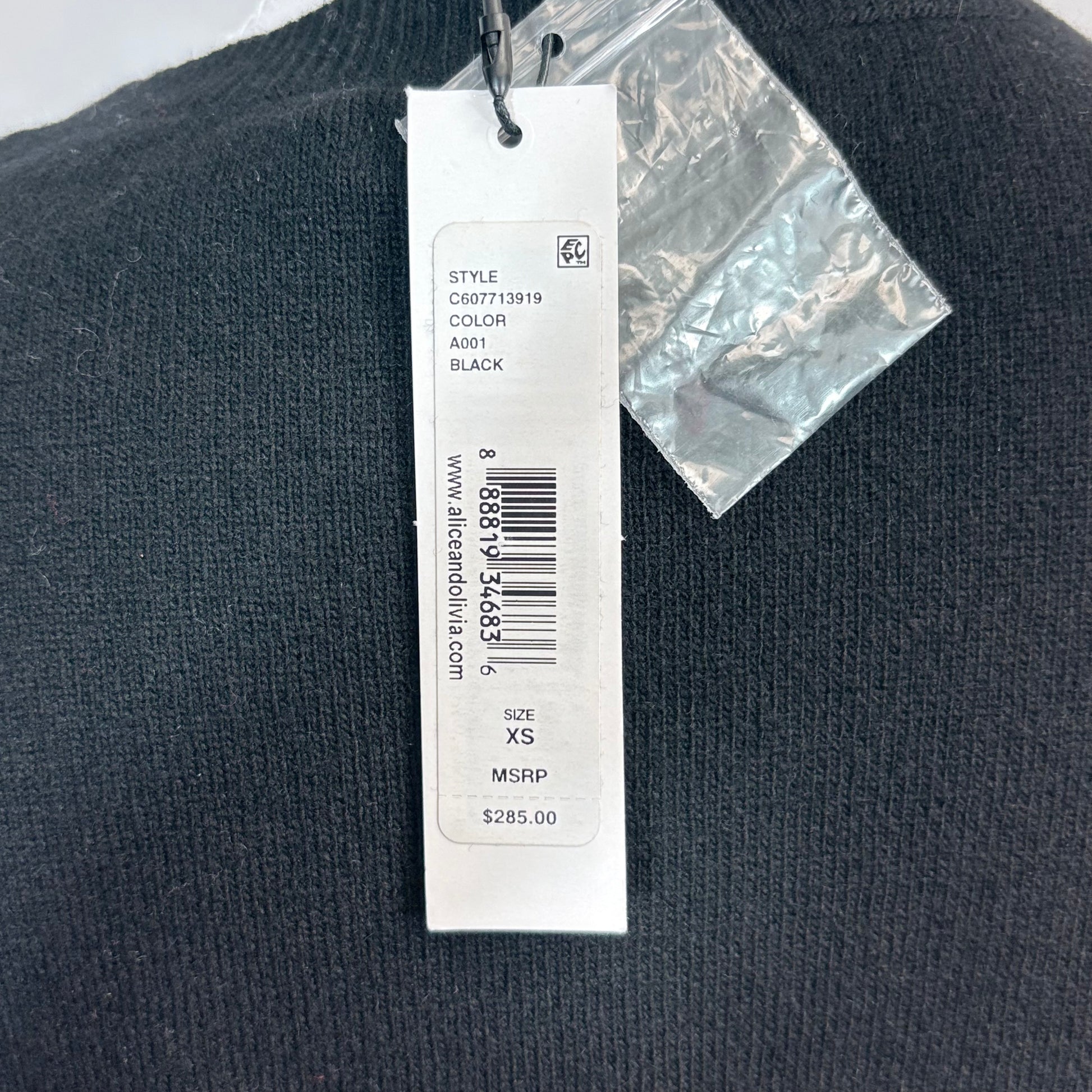 Black sweater with a tag displaying size and price information.