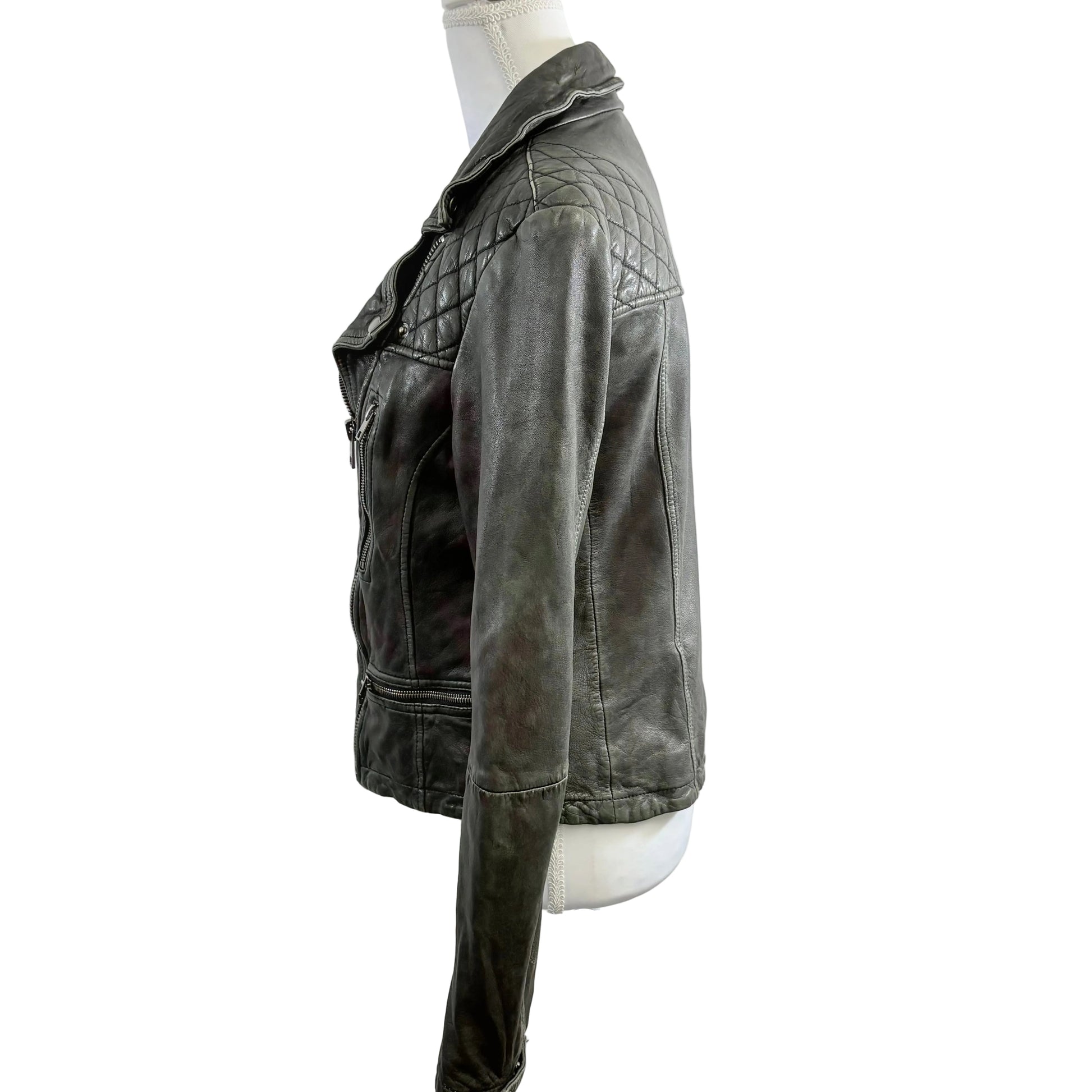 Dark leather jacket on a mannequin against a white background