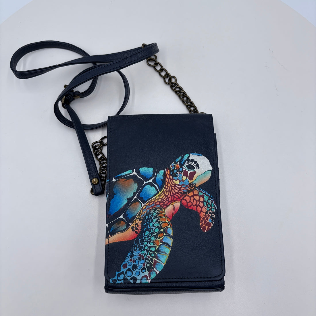 Black wallet with a colorful turtle design on a white background