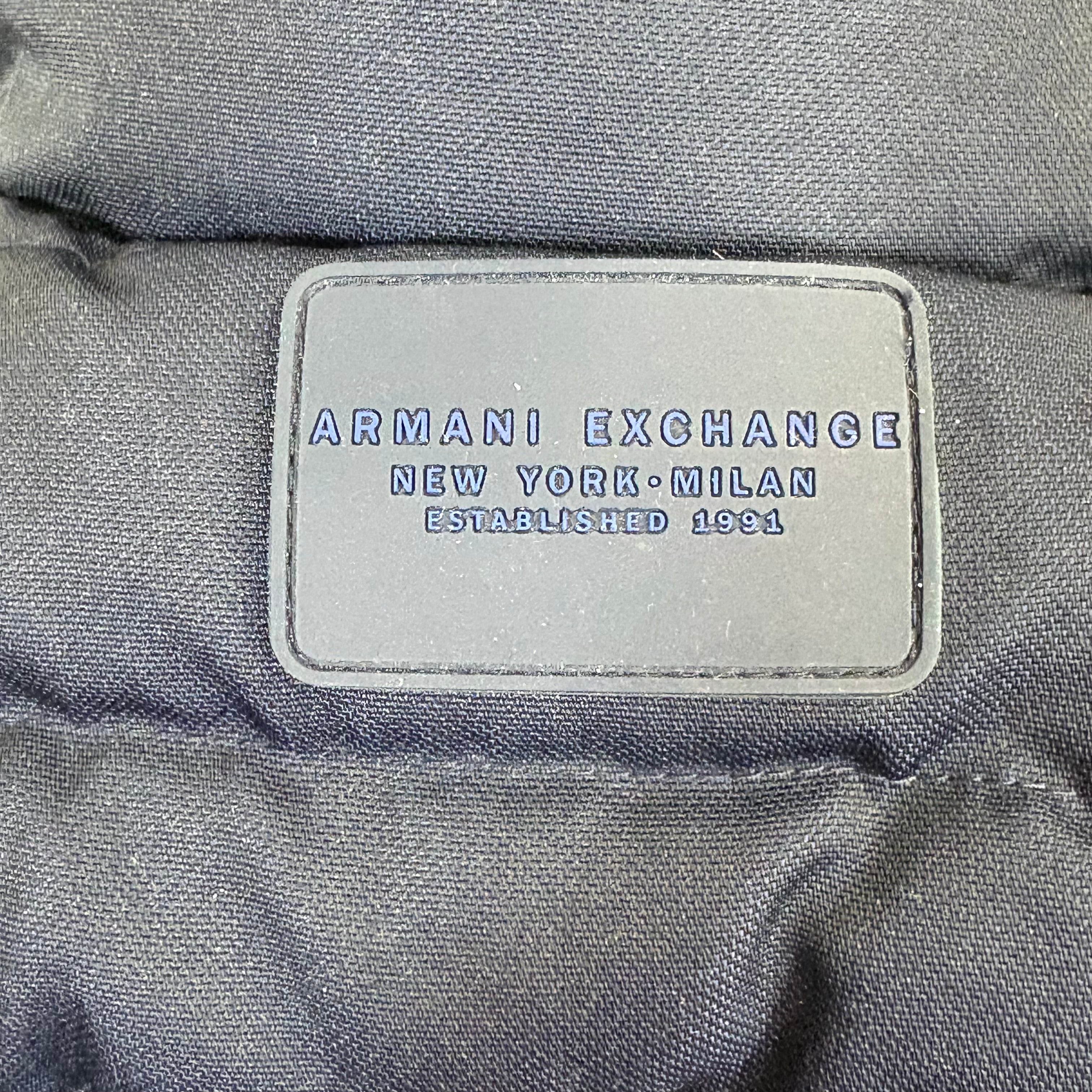 Armani Exchange label on a gray fabric background