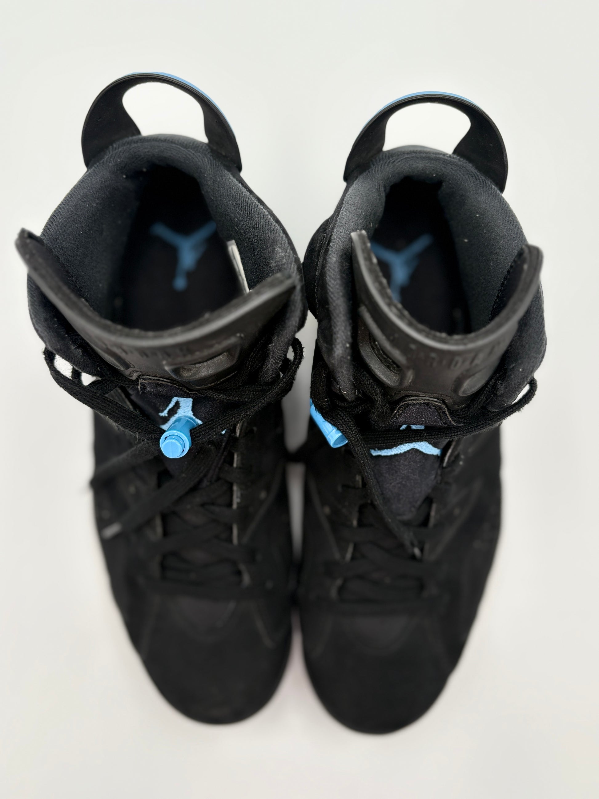 Pair of black high-top sneakers with blue accents on a white background