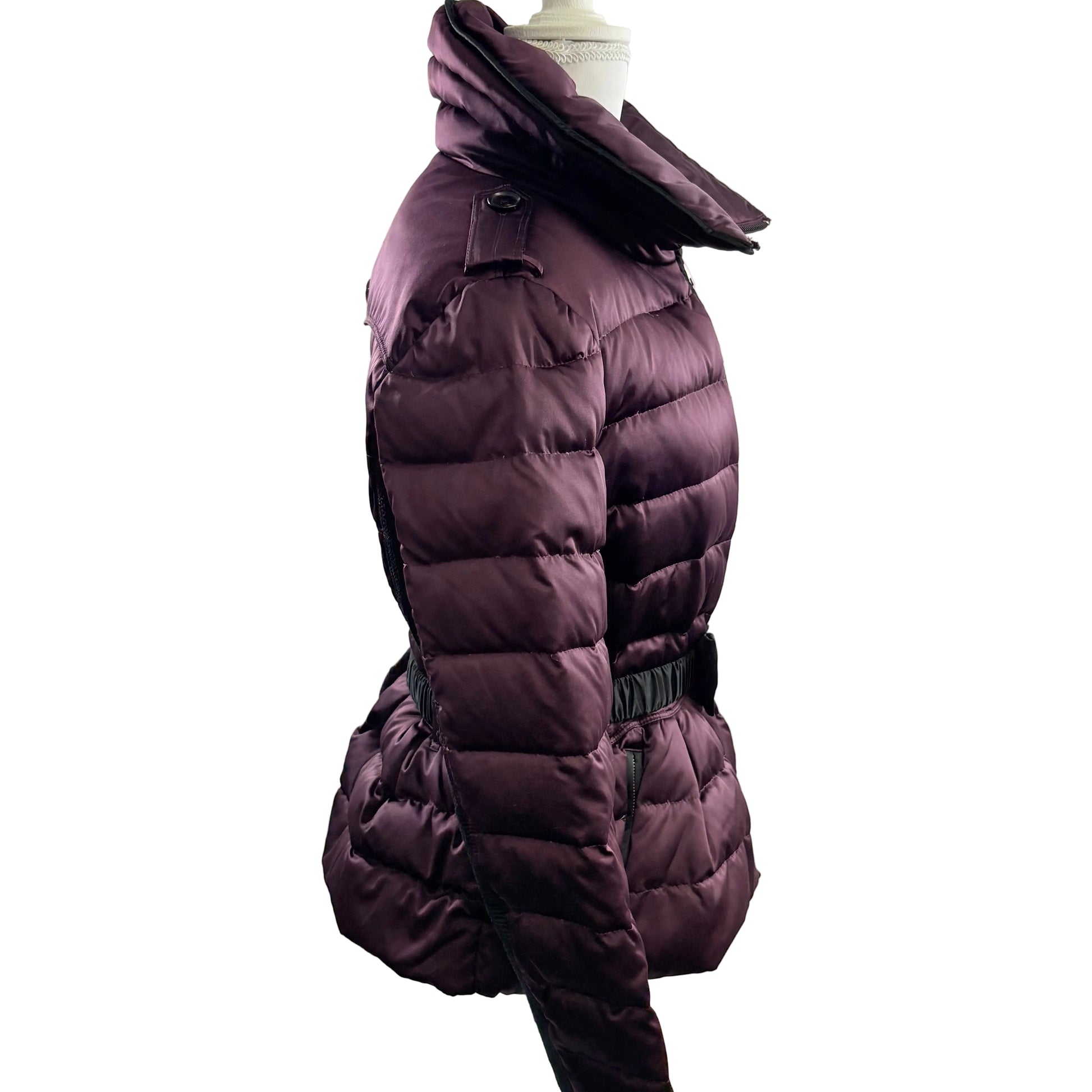 Purple puffer coat on a mannequin against a white background