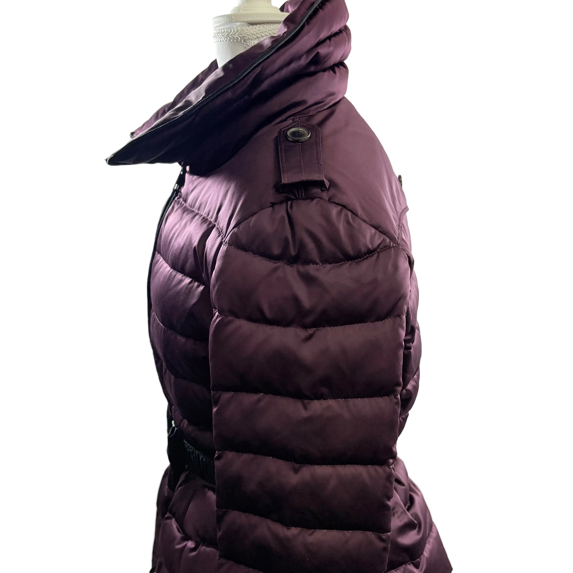 Purple puffer coat on a mannequin against a white background