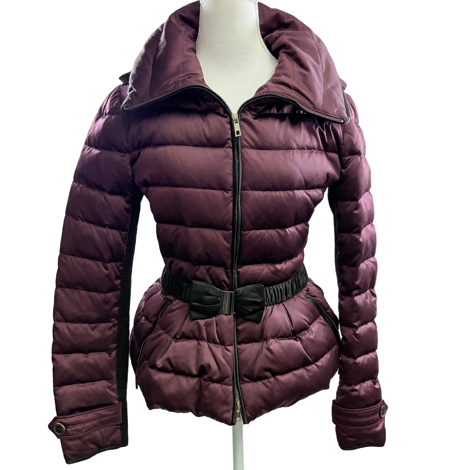 Purple puffer jacket on a mannequin against a white background