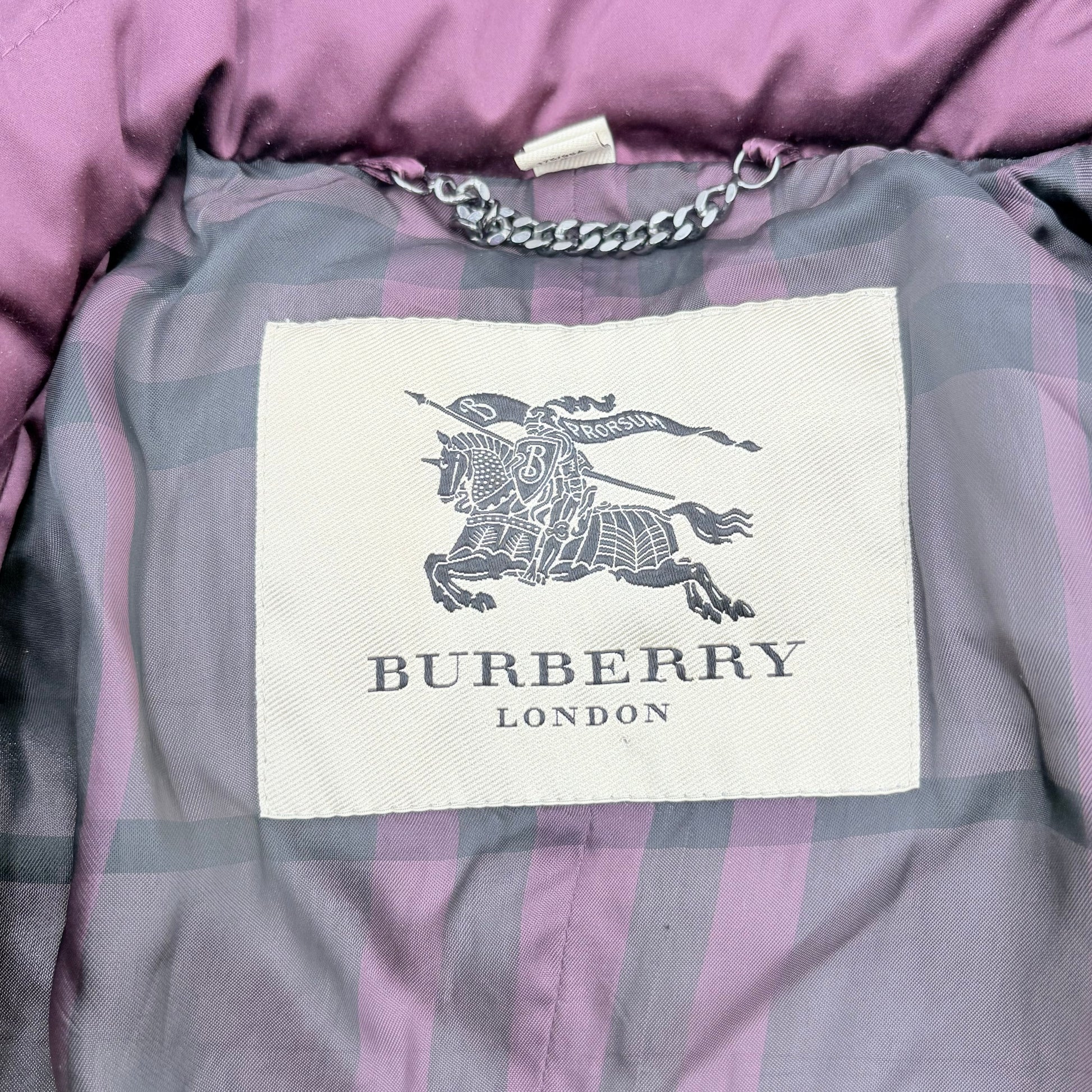 Burberry label on a checkered garment with a purple background