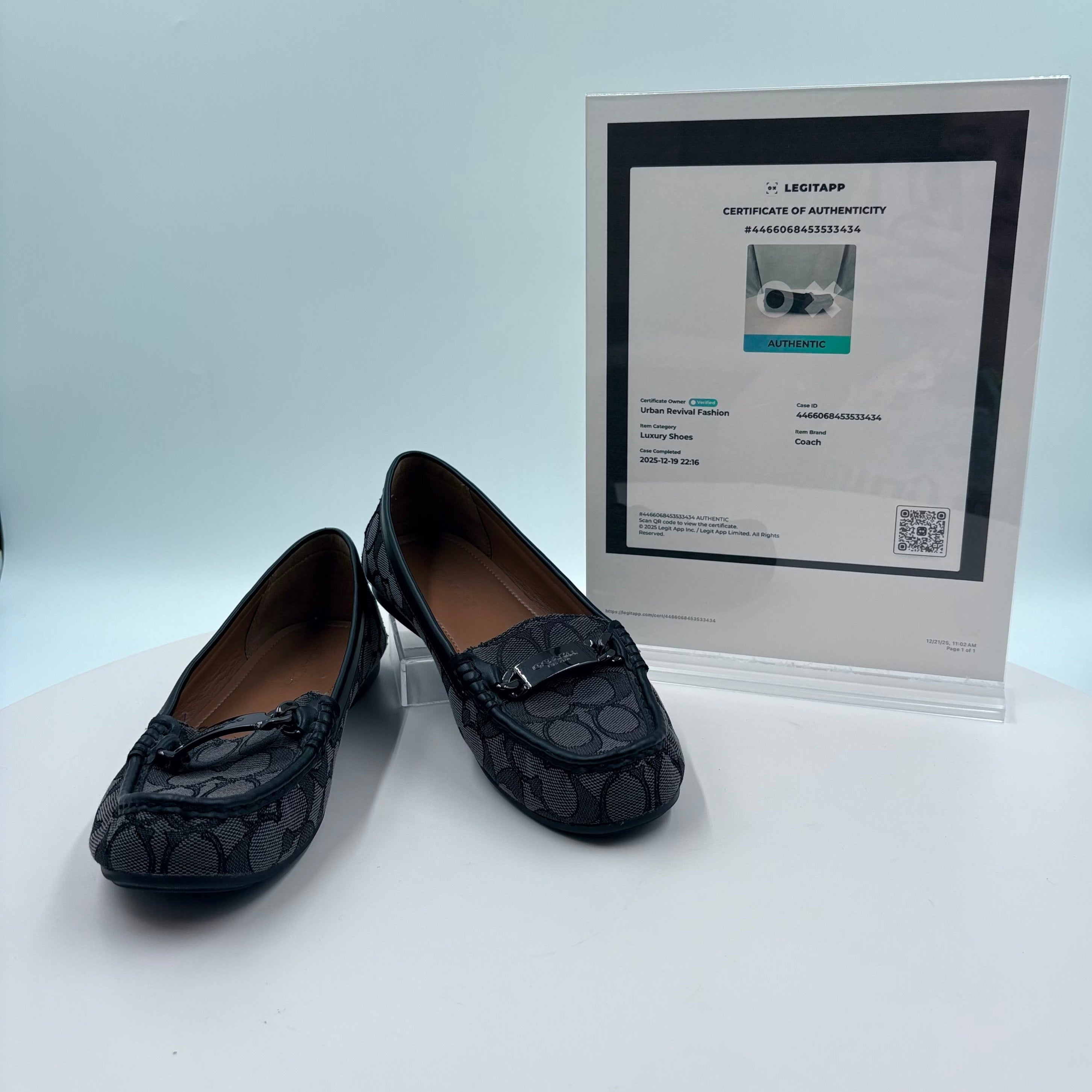 Black loafers with a certificate of authenticity on a white background