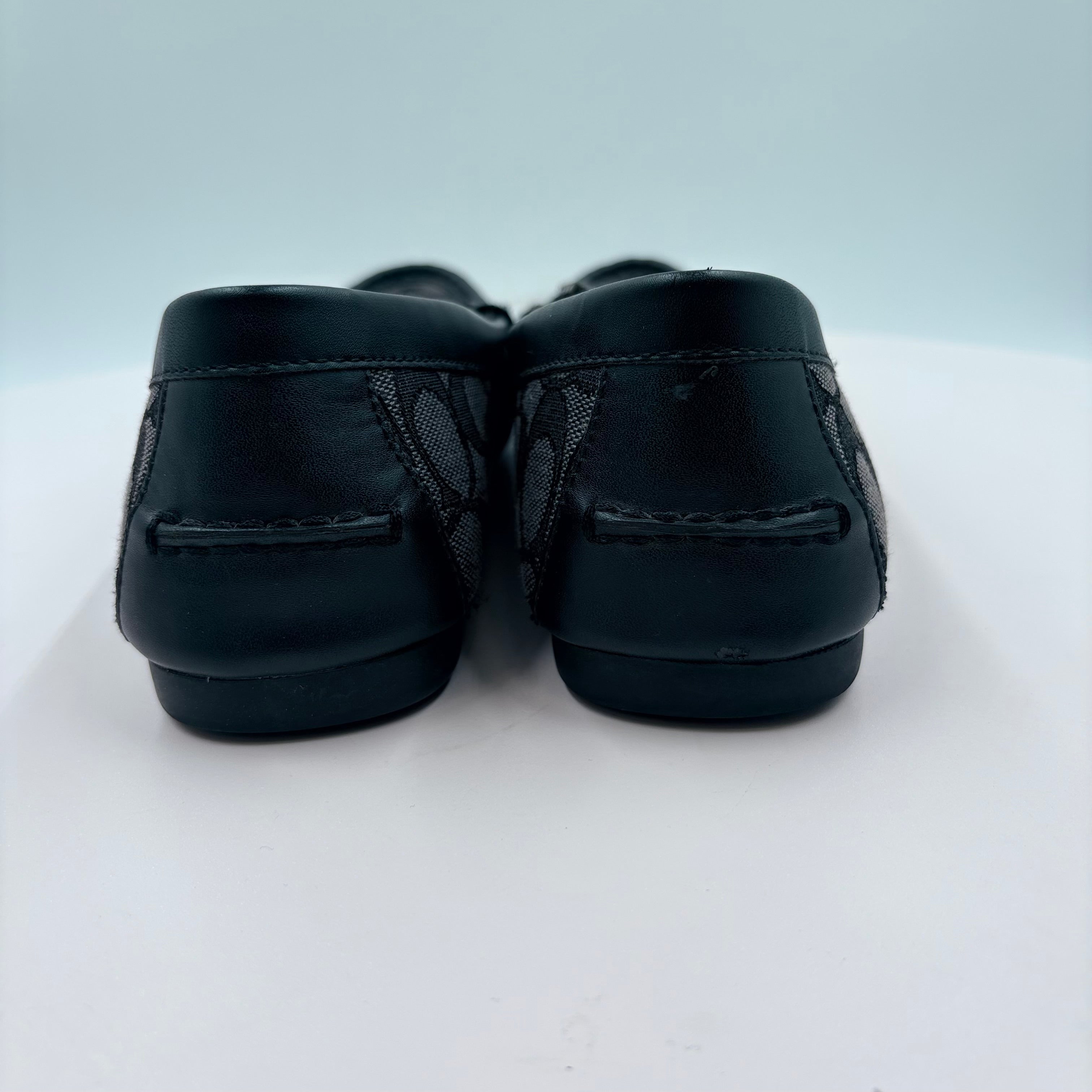 Pair of black loafers on a white background