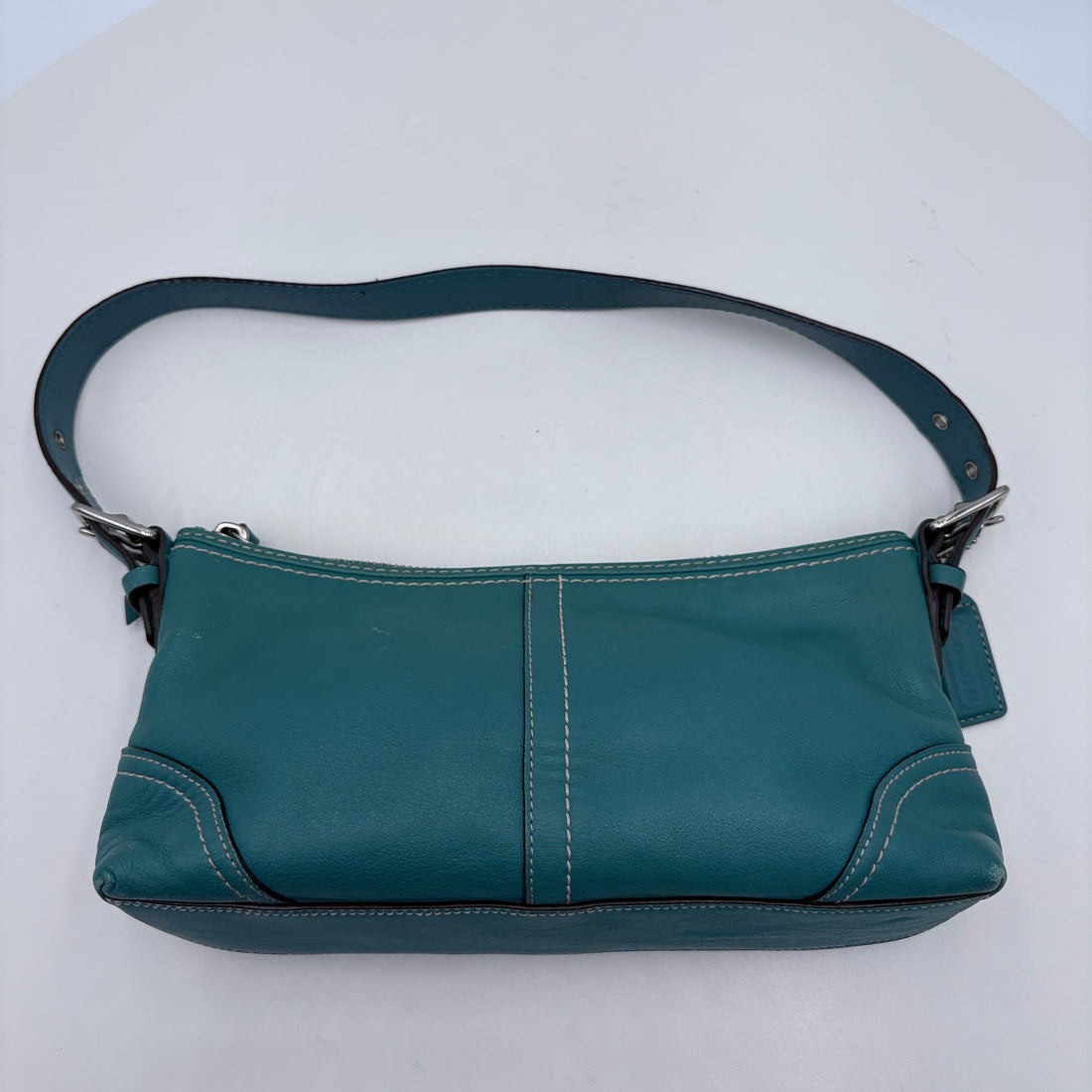 Teal handbag on a white background