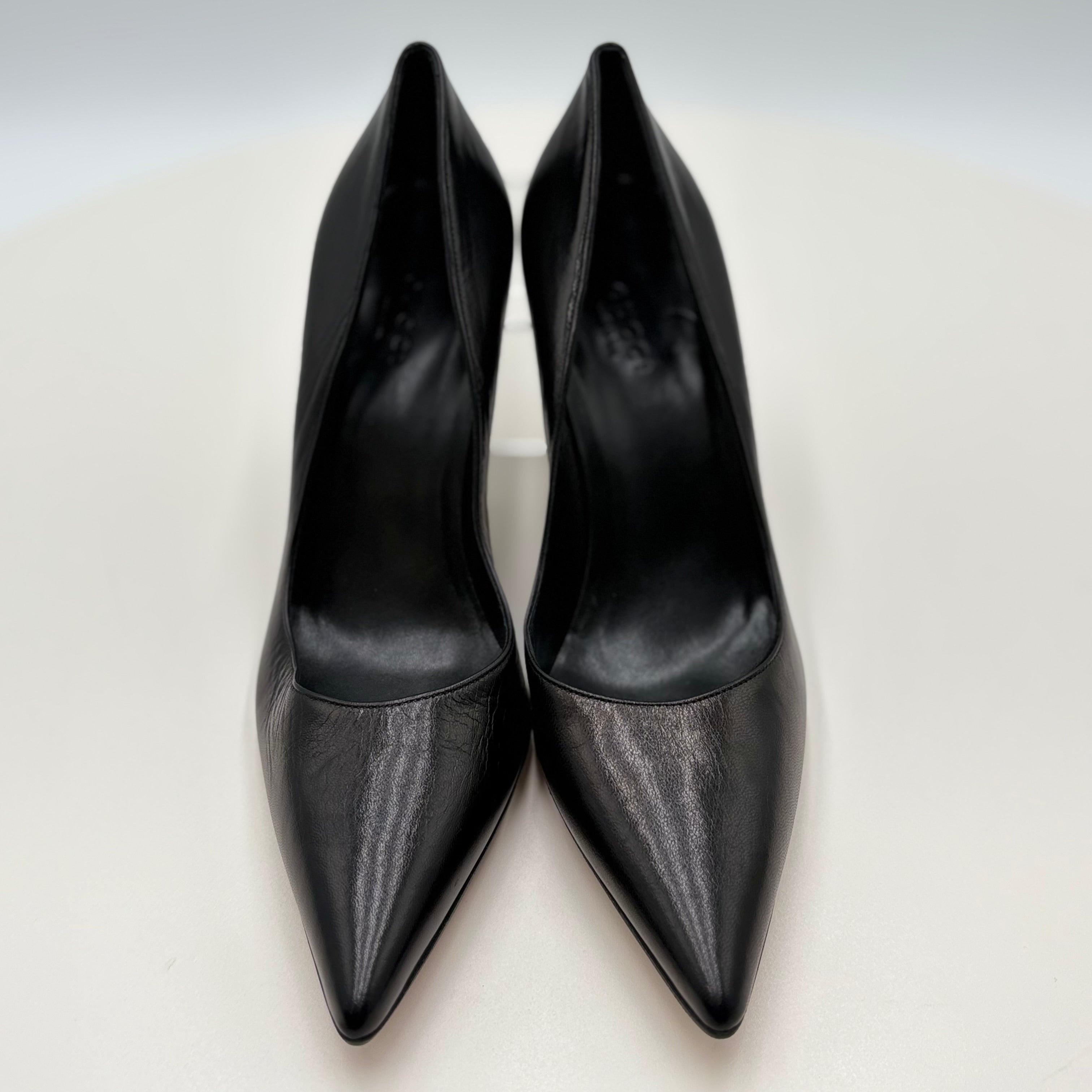 Pair of black high-heeled shoes on a light gray background