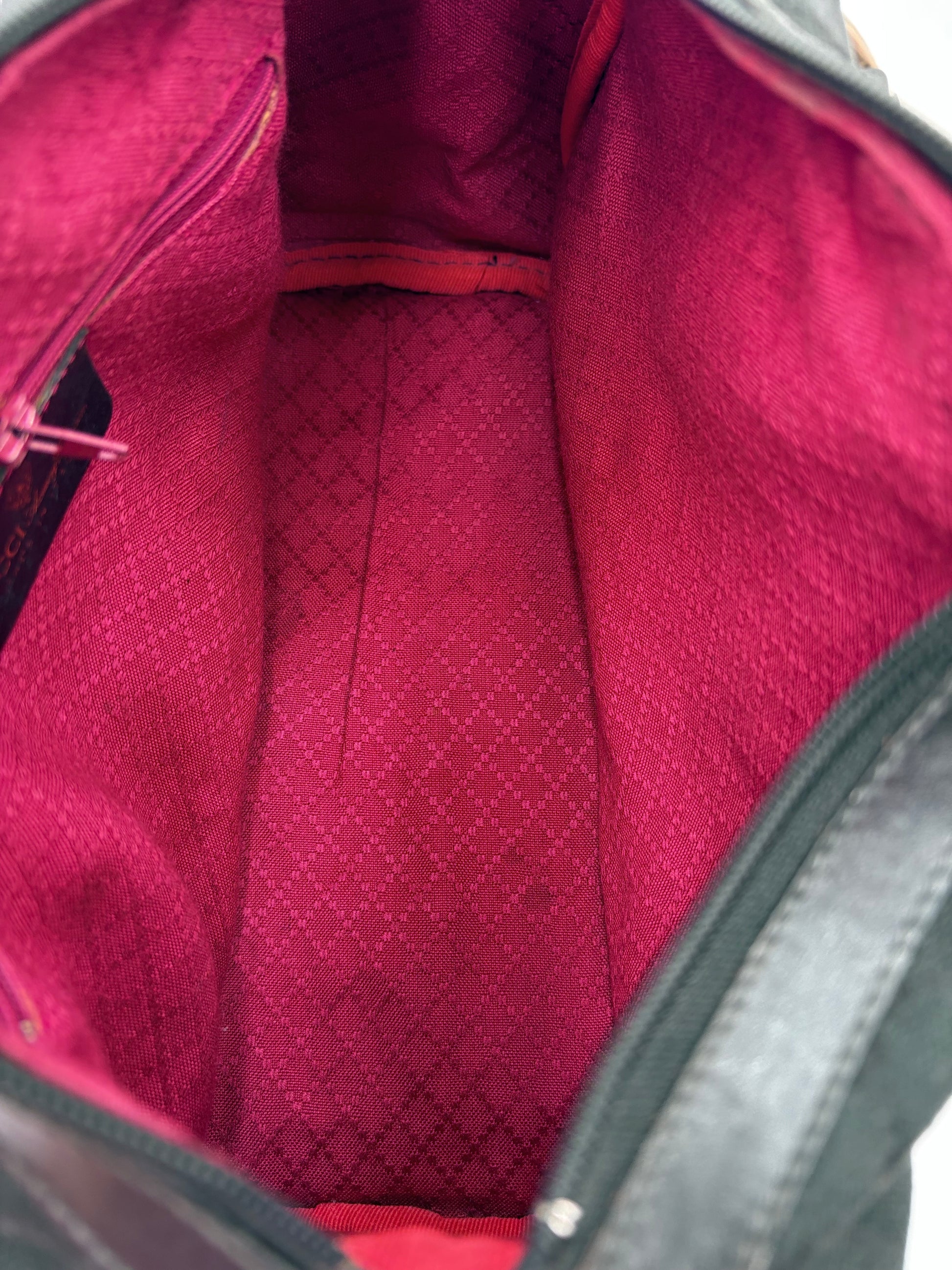 Close-up of a red textured fabric inside an open bag.