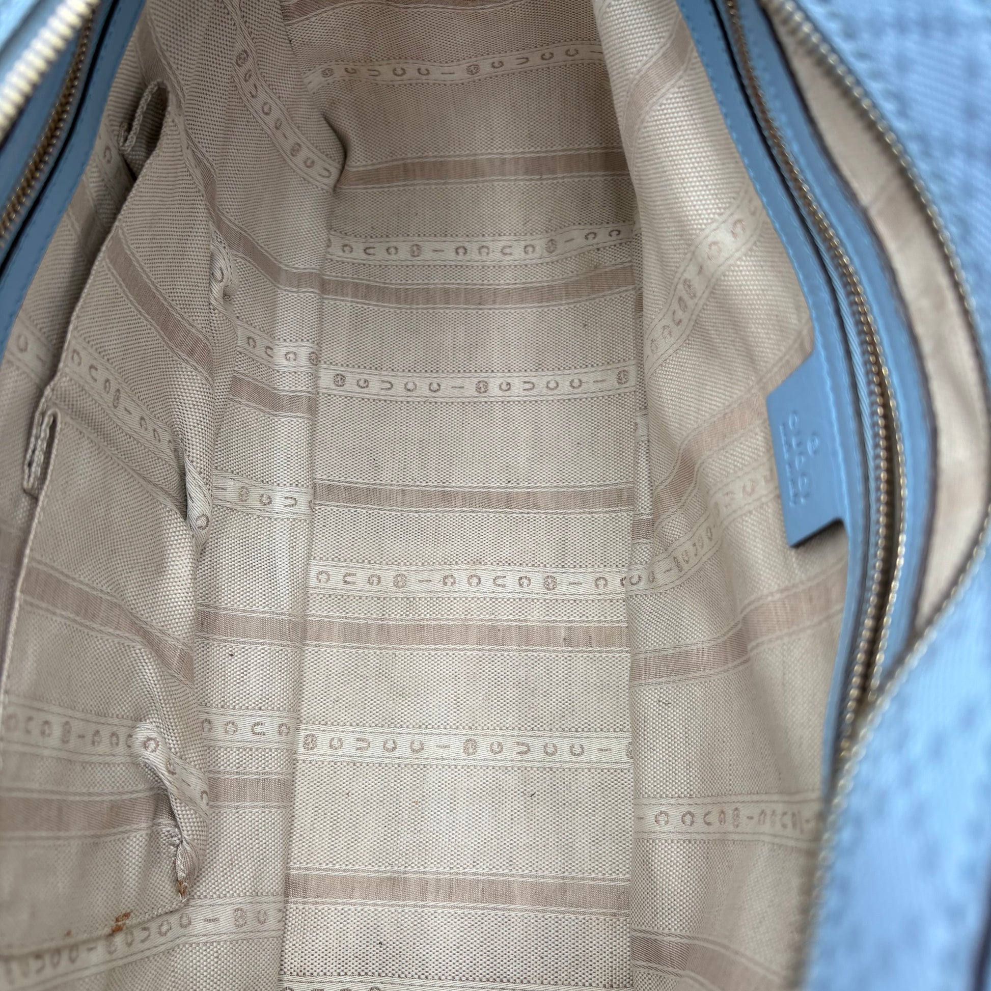 Close-up of a textured fabric with a pattern, possibly from a garment or bag.