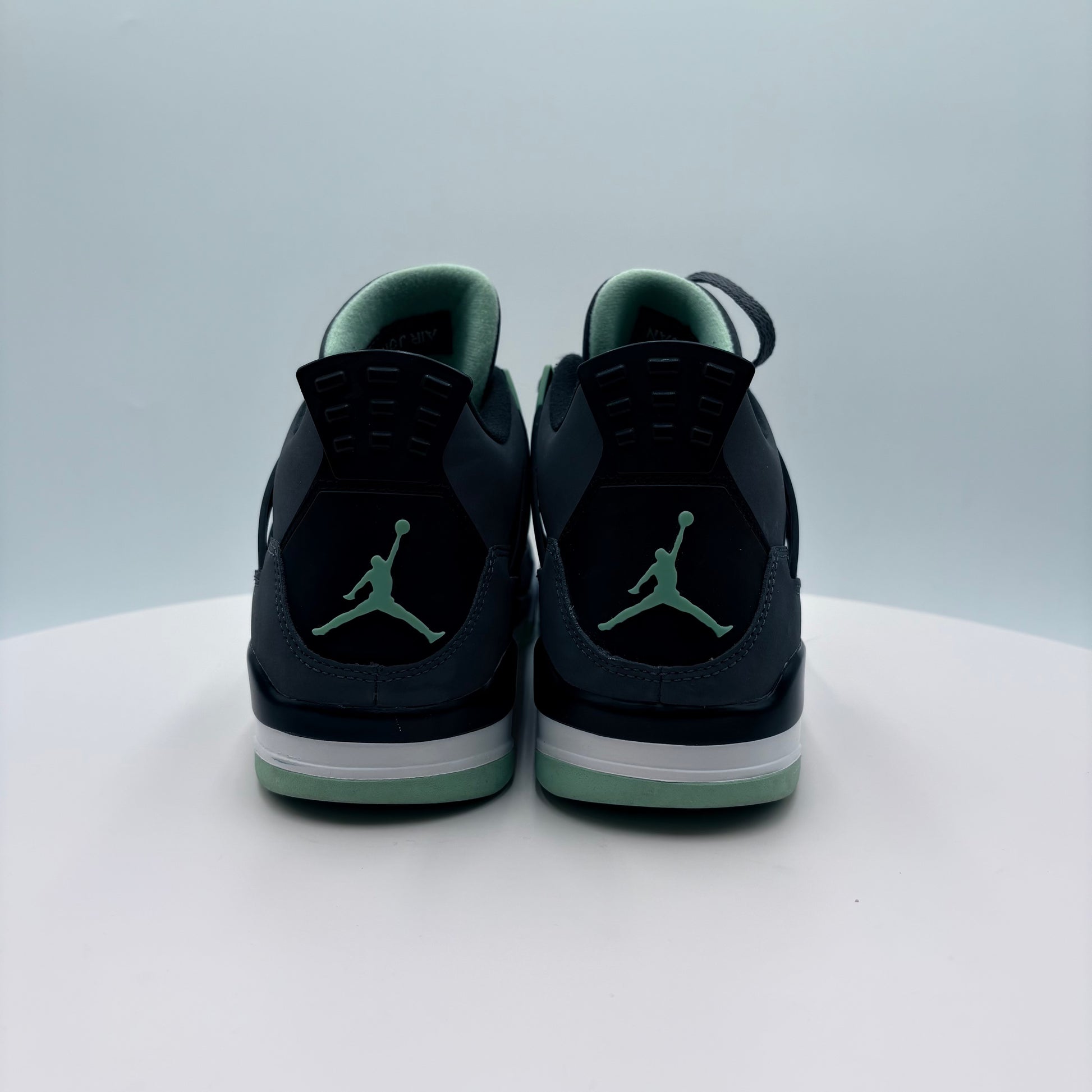 Black sneakers with  Air Jordan logo on a light gray background