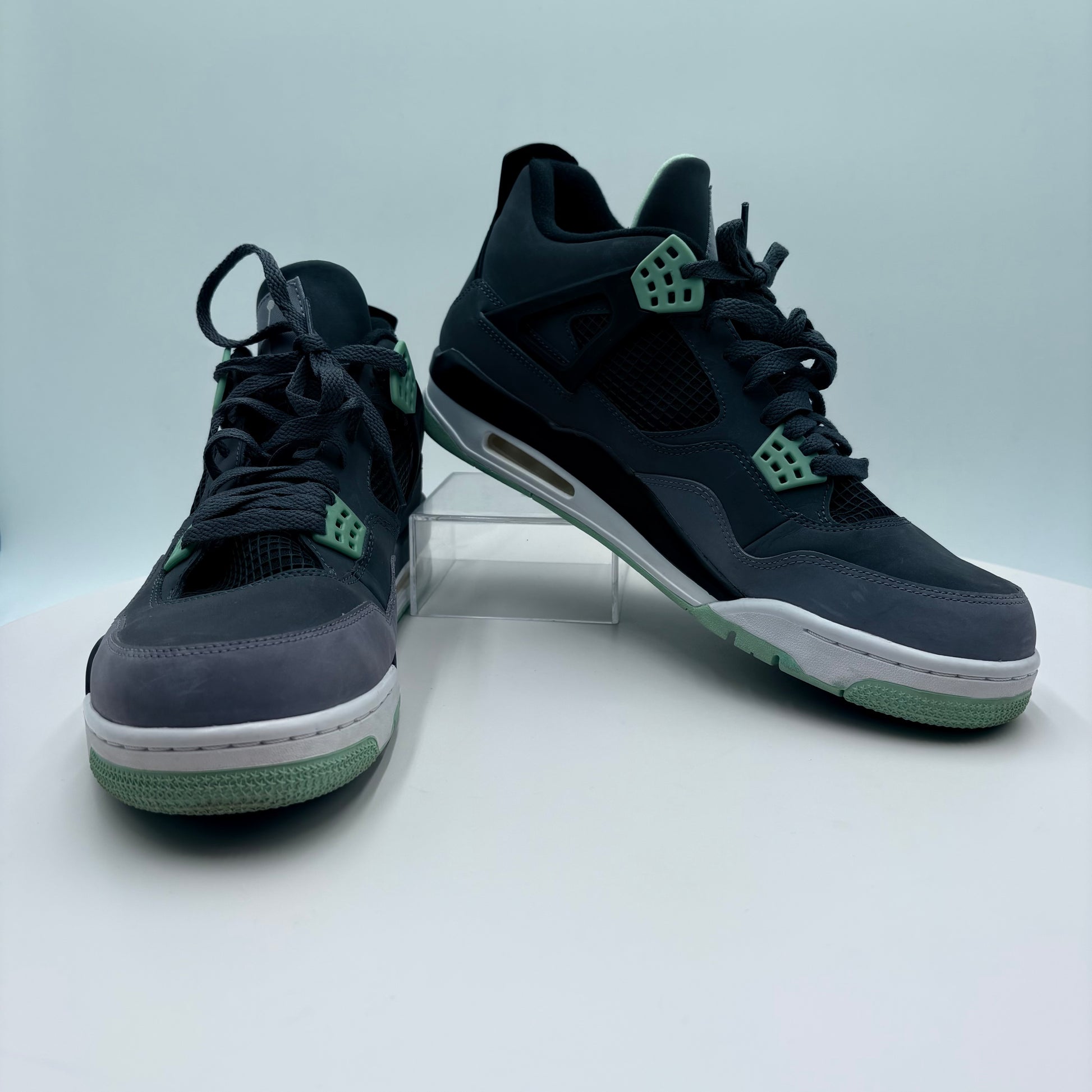 Pair of black and green sneakers on a white background