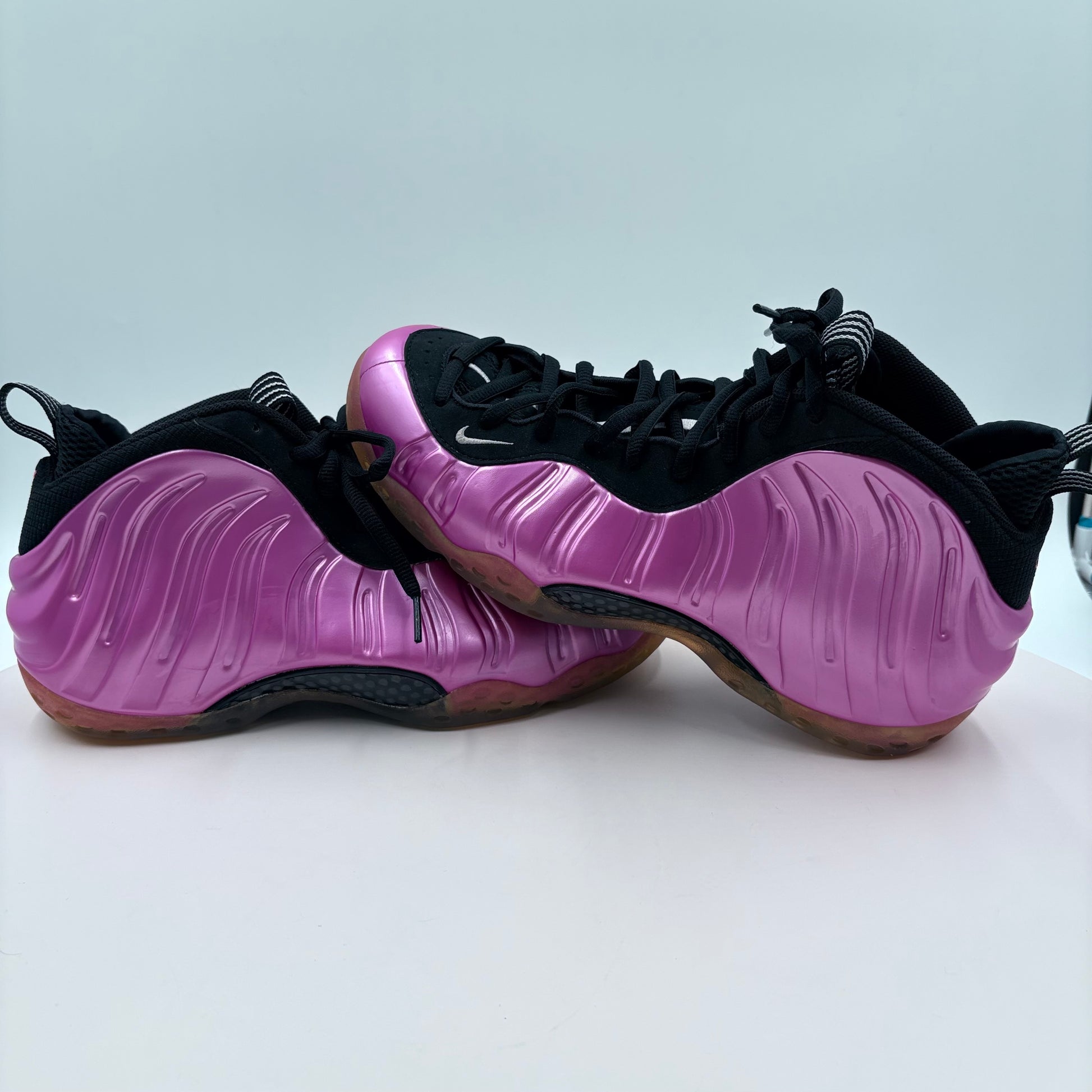 Purple and black sneakers on a light gray background