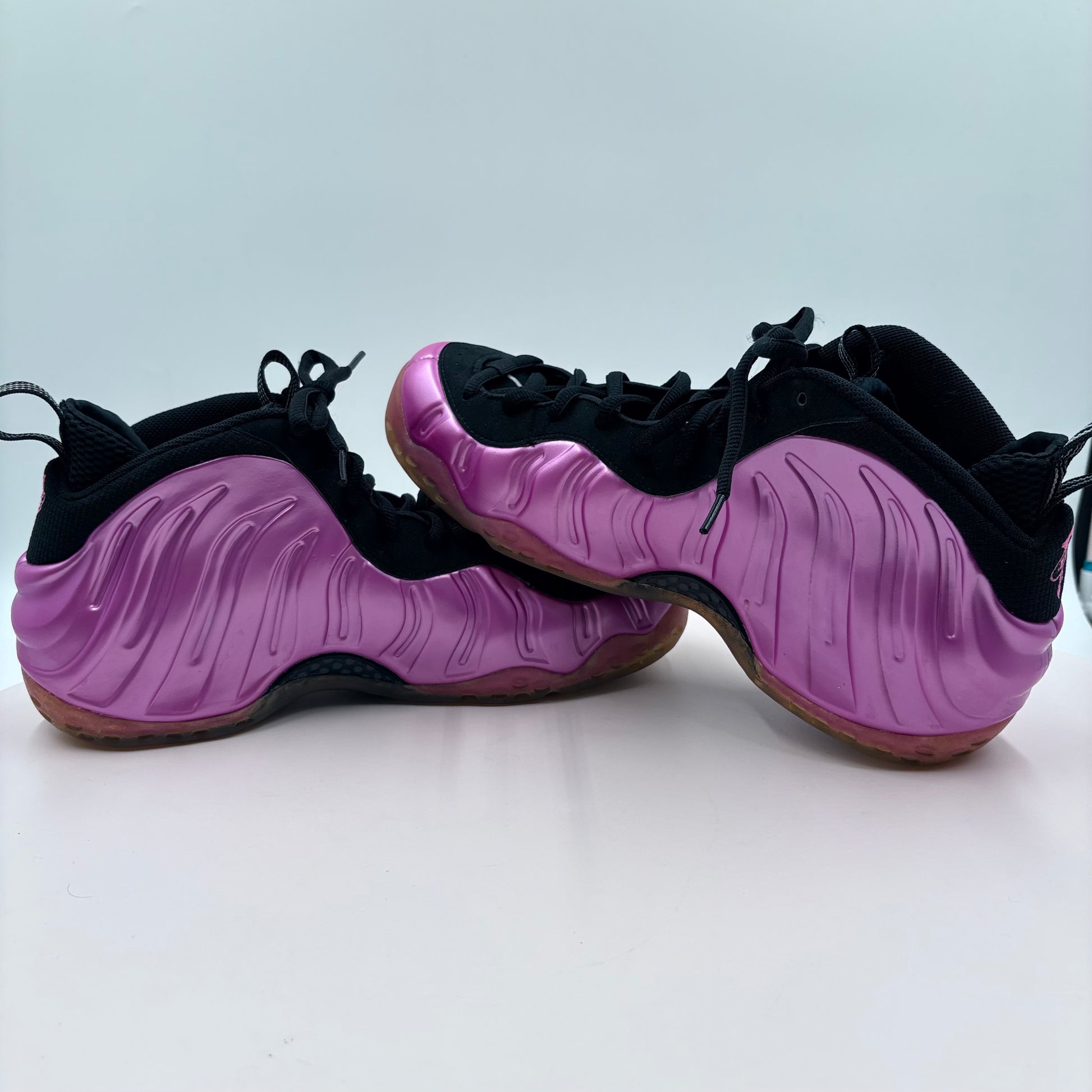 Purple and black shoes on a light gray background