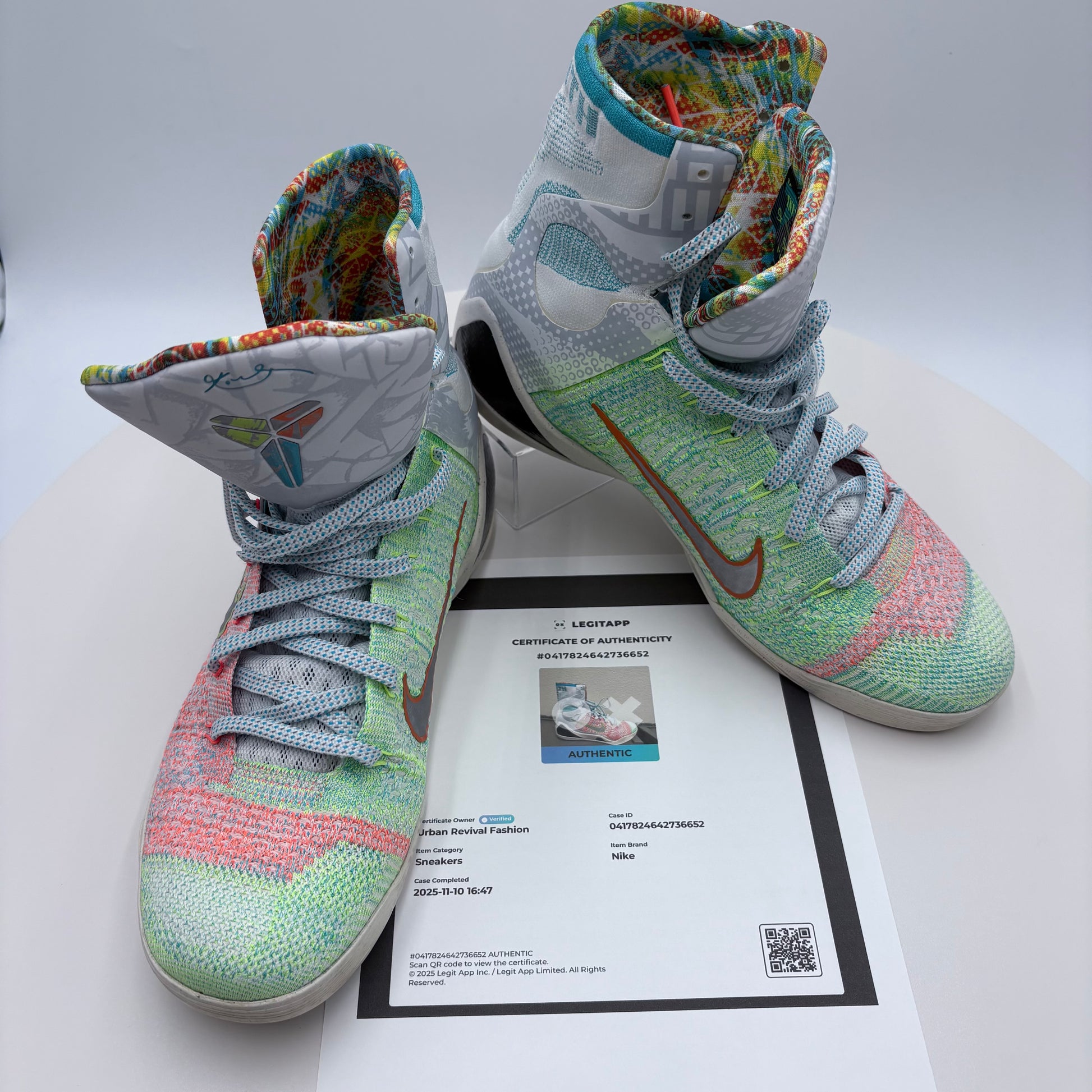 Colorful high-top sneakers on a white surface with a certificate underneath
