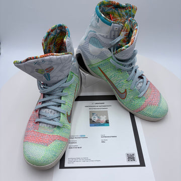 Colorful high-top sneakers on a white surface with a certificate underneath