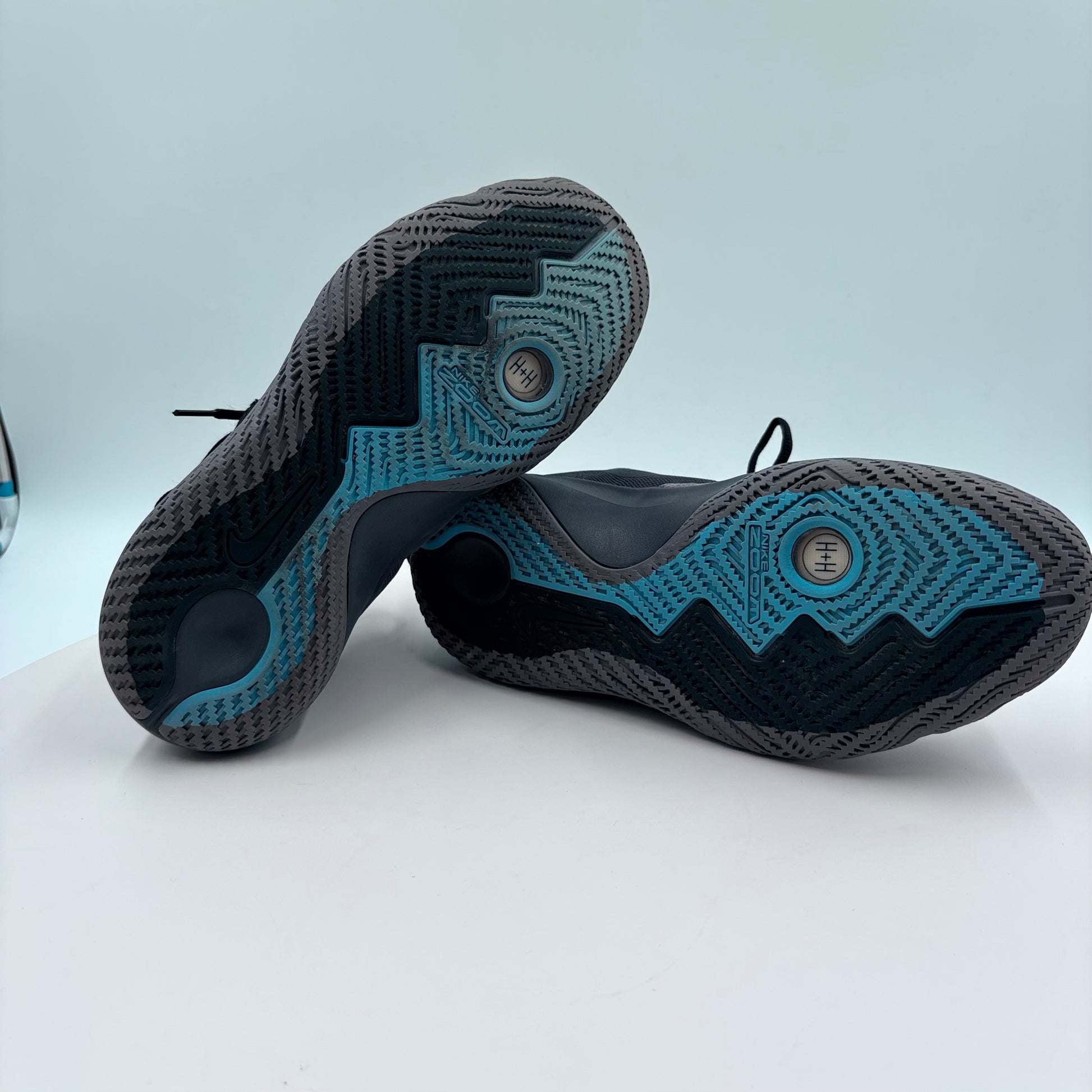 Black and blue textured shoes on a light gray background