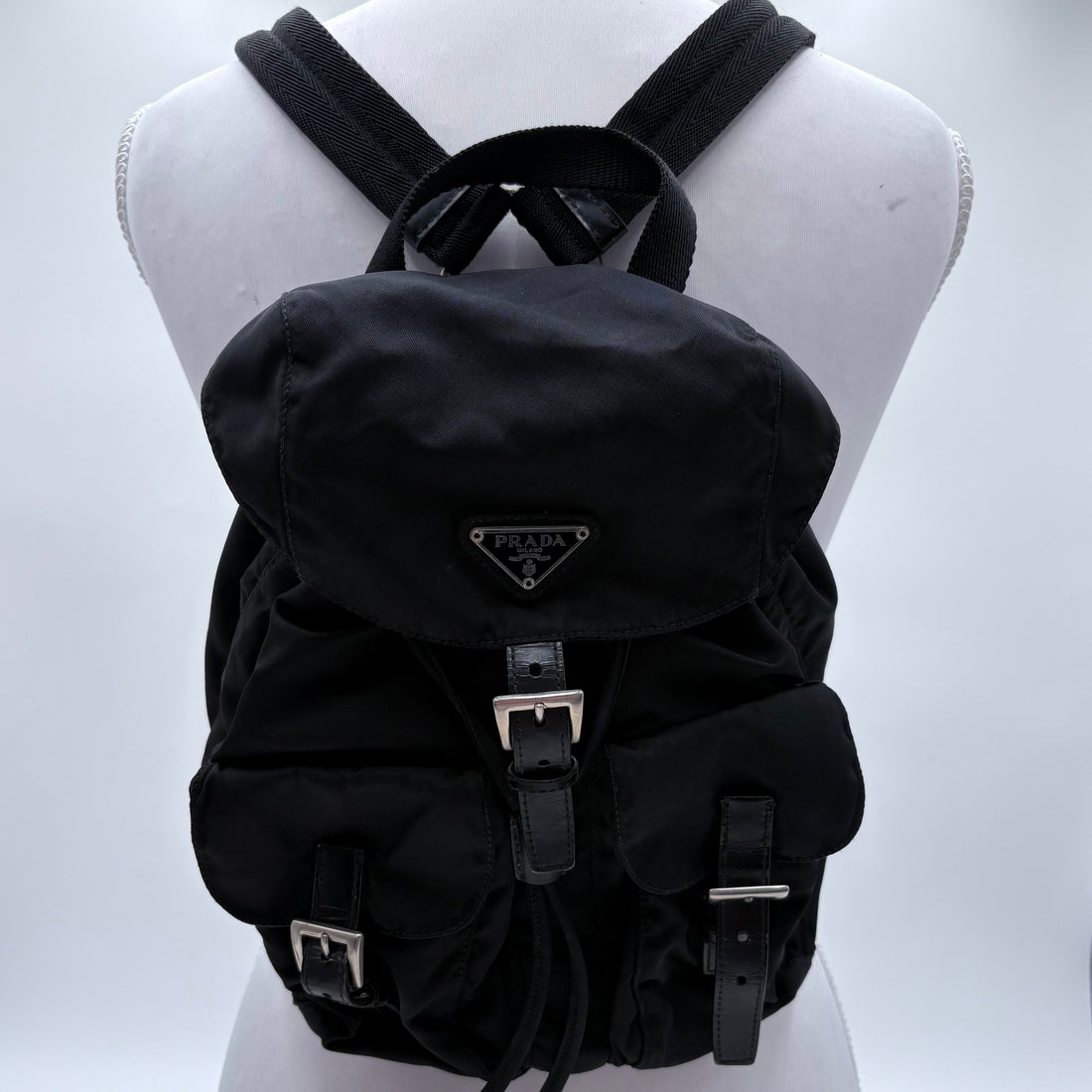 Black backpack on a mannequin with a white background