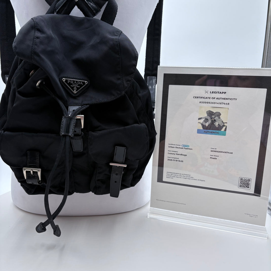 Black backpack on a mannequin with a white background