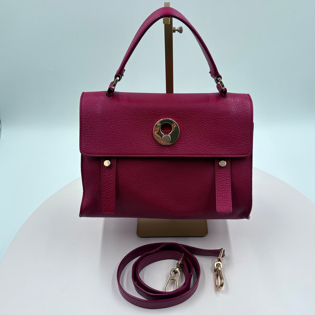 red handbag with a strap on a white background