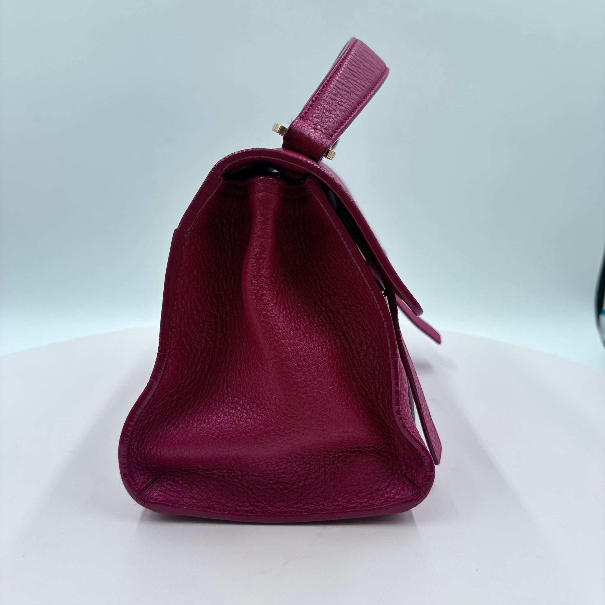 Magenta handbag on a white background