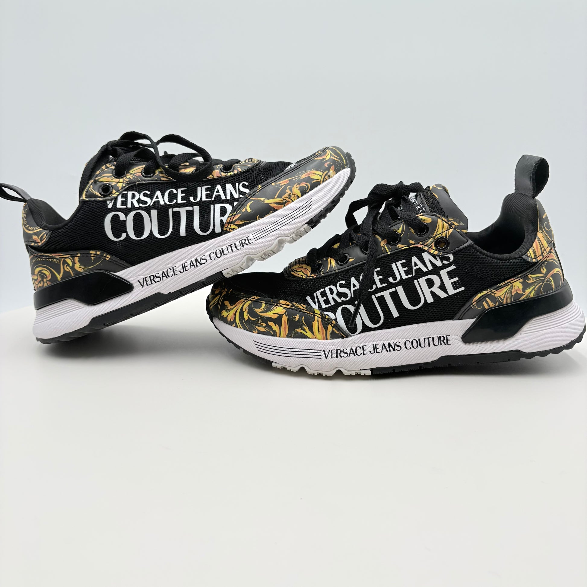 Versace Jeans Couture sneakers with floral design on a light gray background