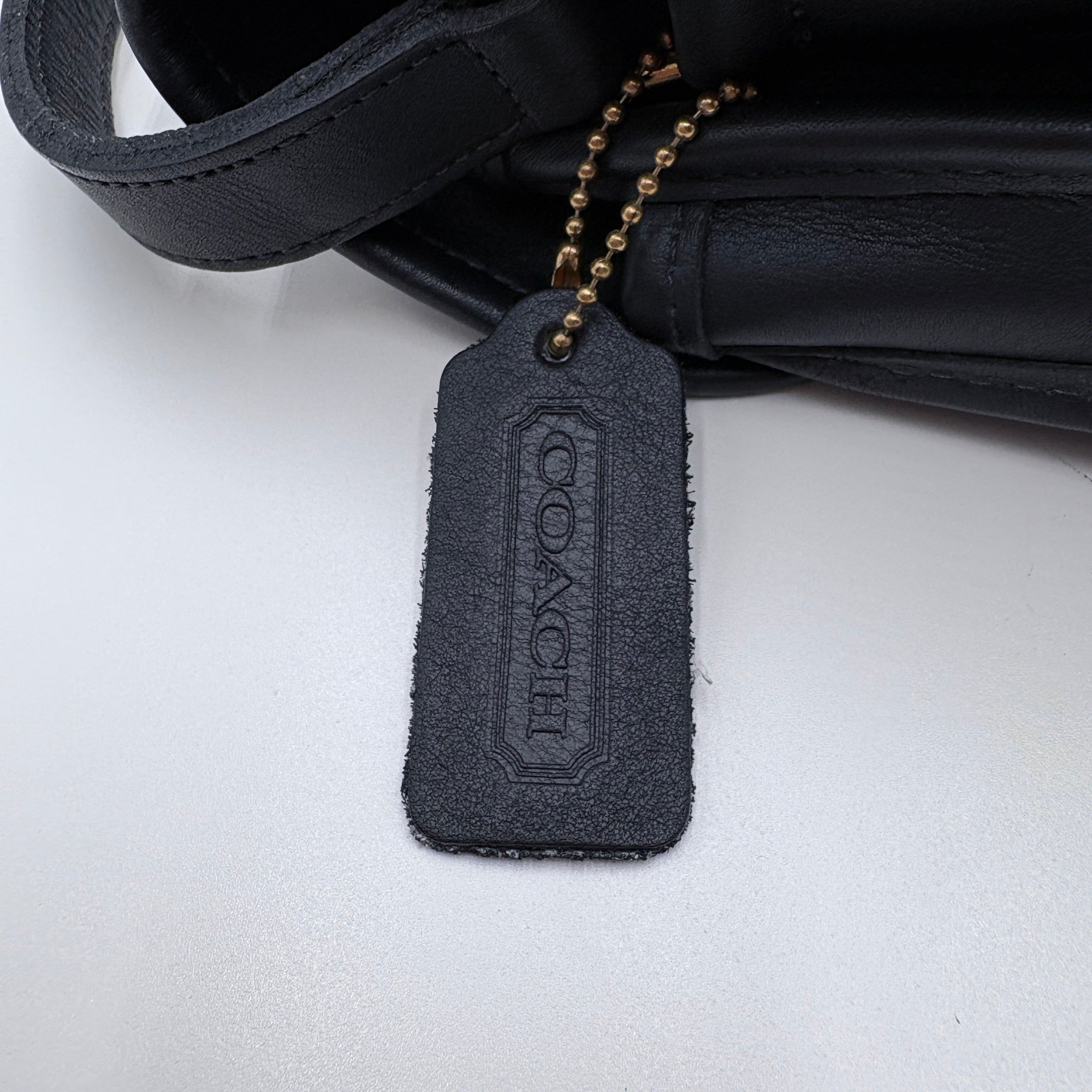 Black Coach tag on a white background