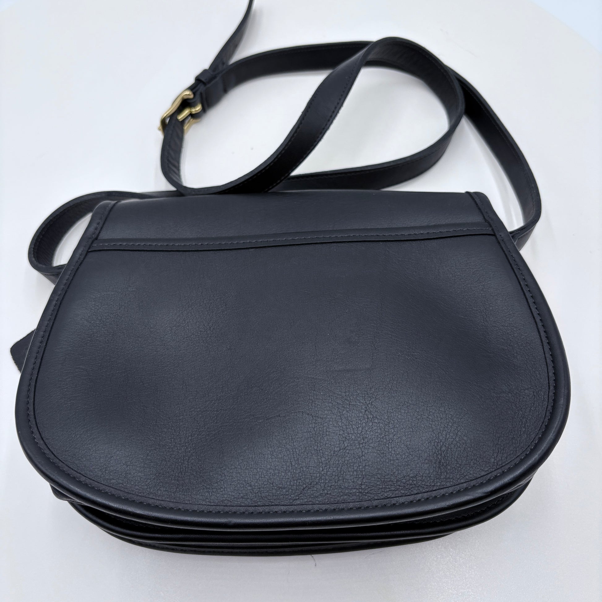 Black leather saddle bag on a white background
