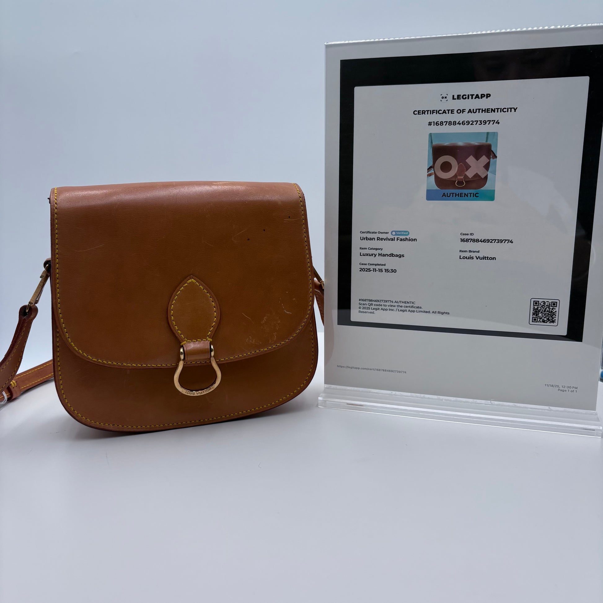 Brown leather bag with a certificate of authenticity on a light gray background