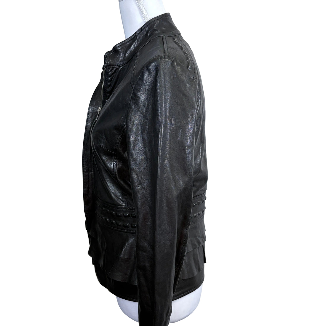 Black leather jacket on a mannequin against a white background