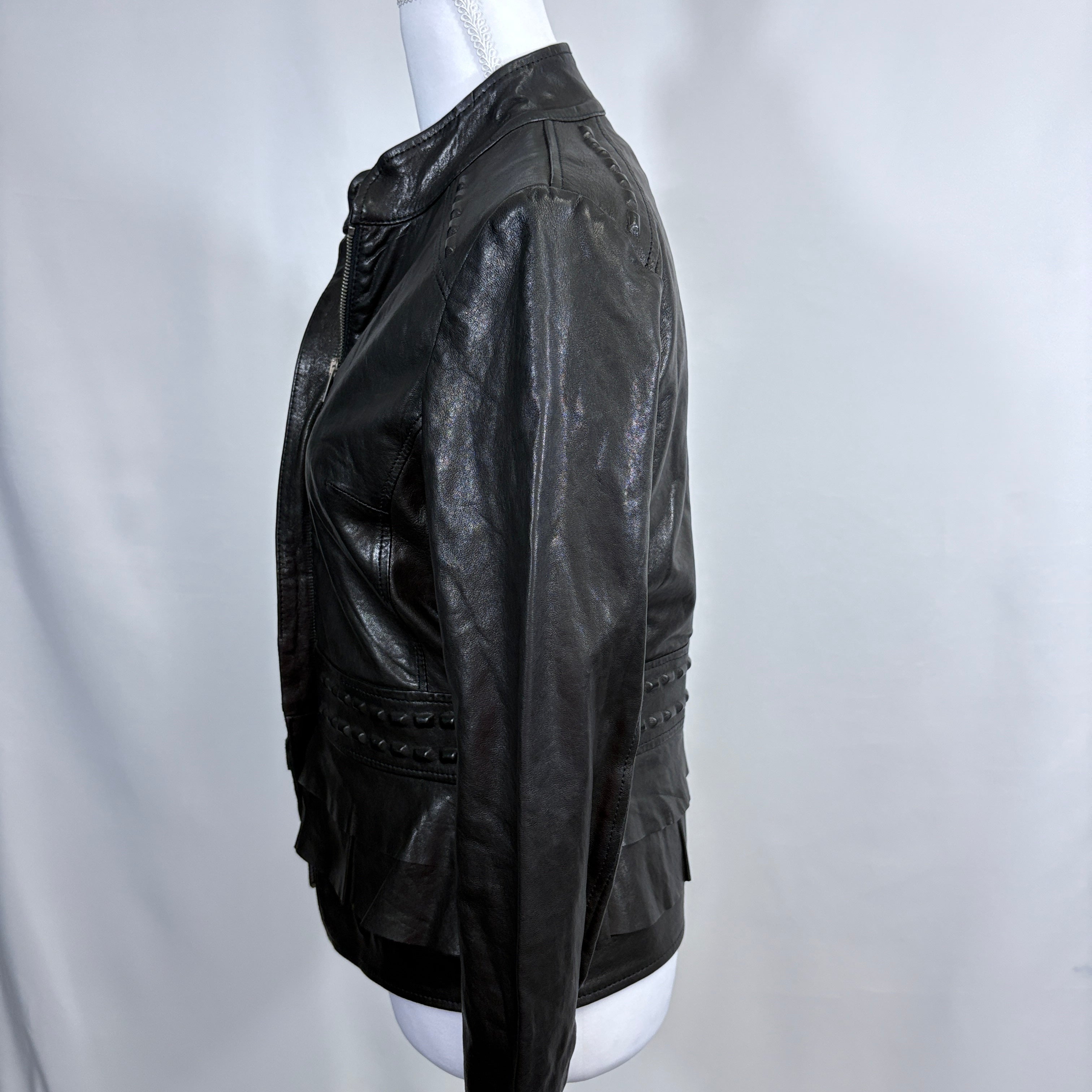 Black leather jacket on a mannequin against a white background - side