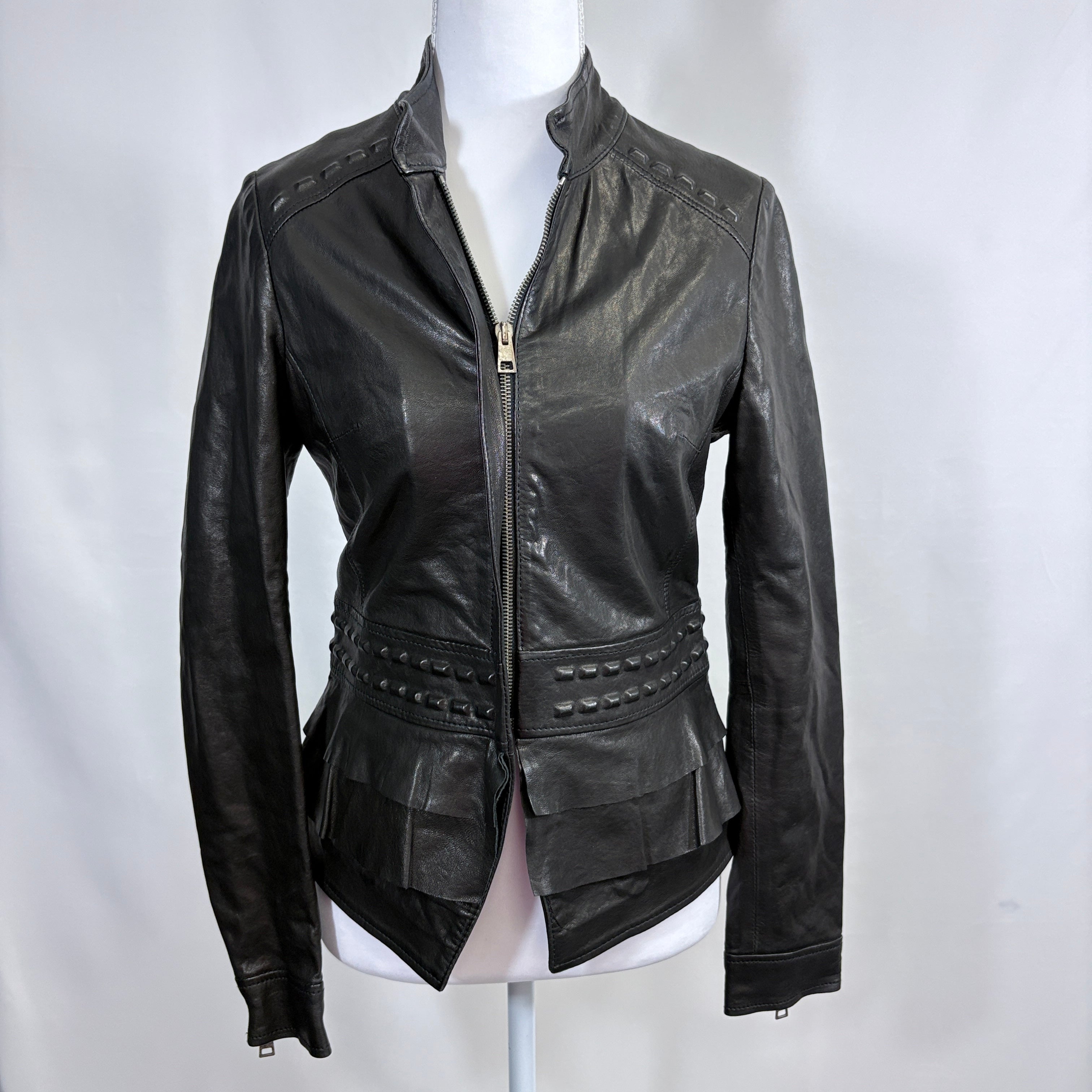Black leather jacket on a mannequin against a white background
