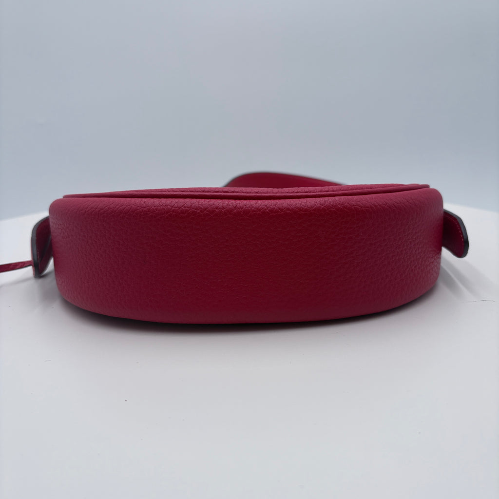 Red leather belt on a white background