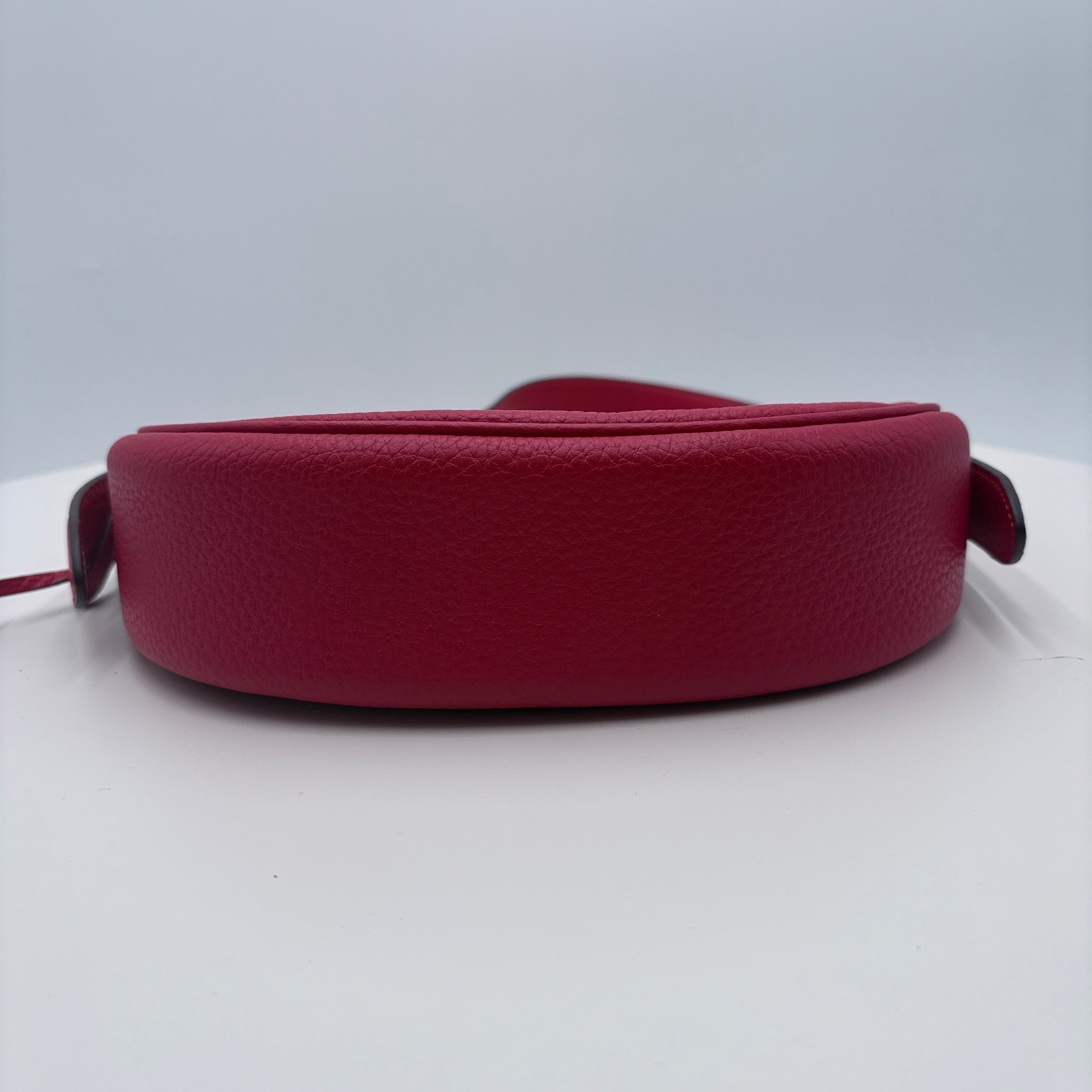 Red leather belt on a white background