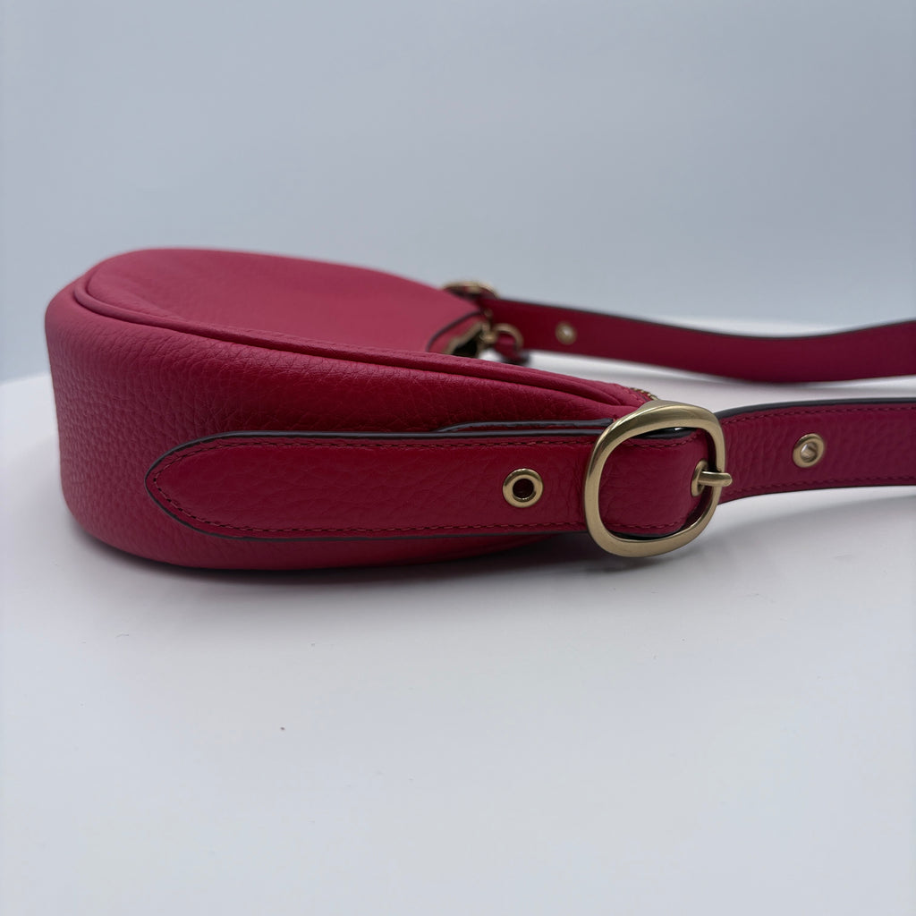Red handbag with a gold buckle on a white background